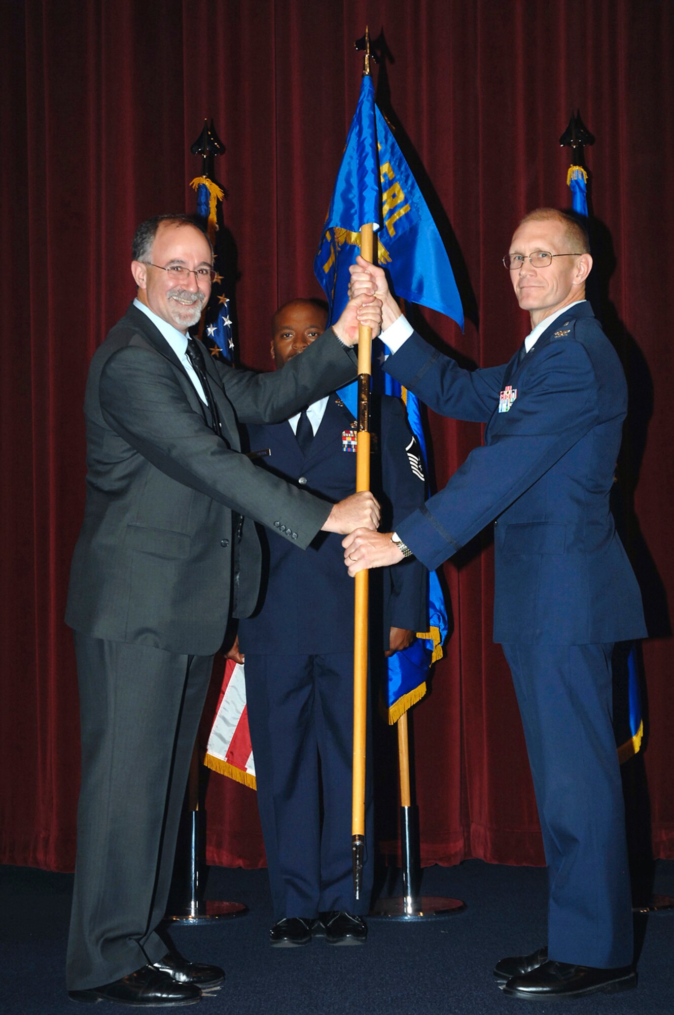 Mr. Joe Sciabica hands over command of the Air Force Research Laboratory's Air Vehicles Directorate and Wright Research Site to Col. Michael C. Hatfield during a July 15 ceremony at Wright-Patterson Air Force Base. Col. Hatfield succeeded Col. John B. Wissler. Mr. Sciabica is AFRL executive director.  (U.S. Air Force photo/Al Bright)
