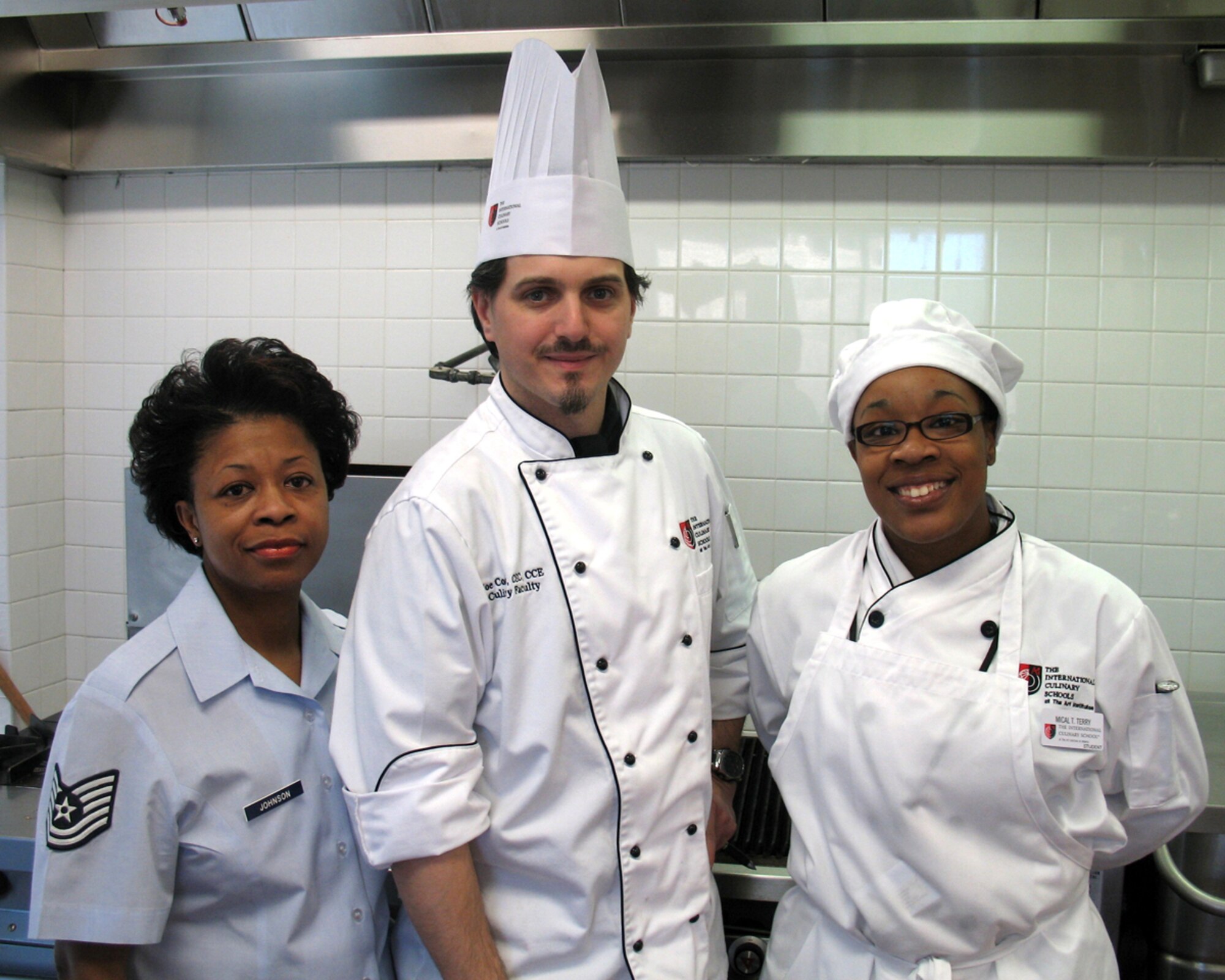 Tech. Sgt. Regena Johnson, 94th Mission Support Squadron, and her daughter, aspiring chef Mical Terry pose with an instructor at The International Culinary School at The Art Institute of Atlanta. Mical recently received a $20,000 scholarship to attend the school by winning an essay contest sponsored by the Food Network show, The Chef Jeff Project. Mical overcame the odds after she was diagnosed with cerebral palsy to fulfill her dreams of becoming a chef. (Courtesy Photo)