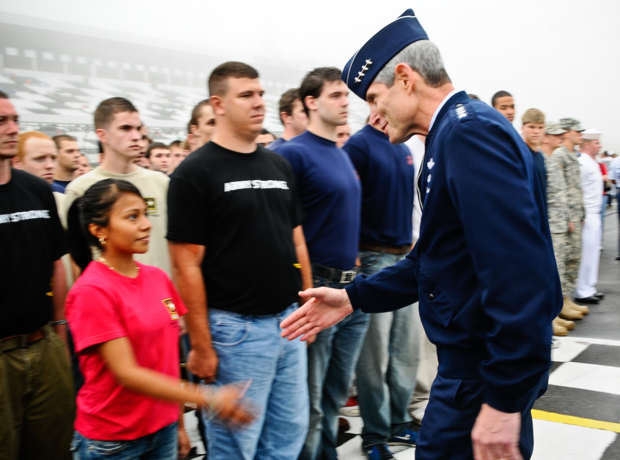 Gen. Norton A. Schwartz, chief of staff of the Air Force, congratulates Delayed Enlistment Program members after swearing them in at the Pocono Motor Raceway Aug. 2 in Pocono, Pa. The DEP is set up for individuals joining the military to have a reserved spot as an inactive reserve prior to their set departure date for basic military training. There were more than 100 DEP members from all branches of service, with 23 joining the U.S. Air Force family. (U.S. Air Force photo by Senior Airman Alexandre Montes)