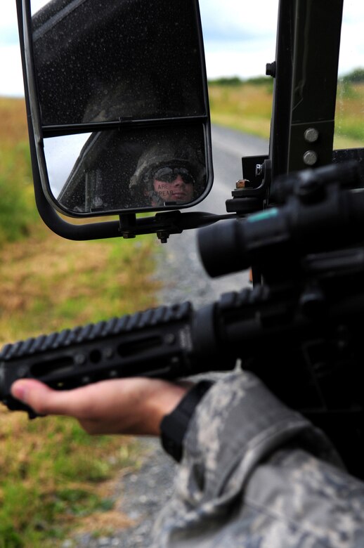 U.S. Air Force Staff Sgt. Bryan Briggs, a Tactical Air Control Party, Joint Terminal Attack Controller, from the 2nd Air Support Operations Squadron, drives a Humvee while maintaining arms during convoy attack training during Allied Strike, Grafenwoehr, Germany, Aug. 3, 2009.  Allied Strike a service, multi-national exercise presents realistic scenarios for participants to hone skills before deploying. (U.S. Air Force photo by Staff Sgt. Jocelyn Rich)
