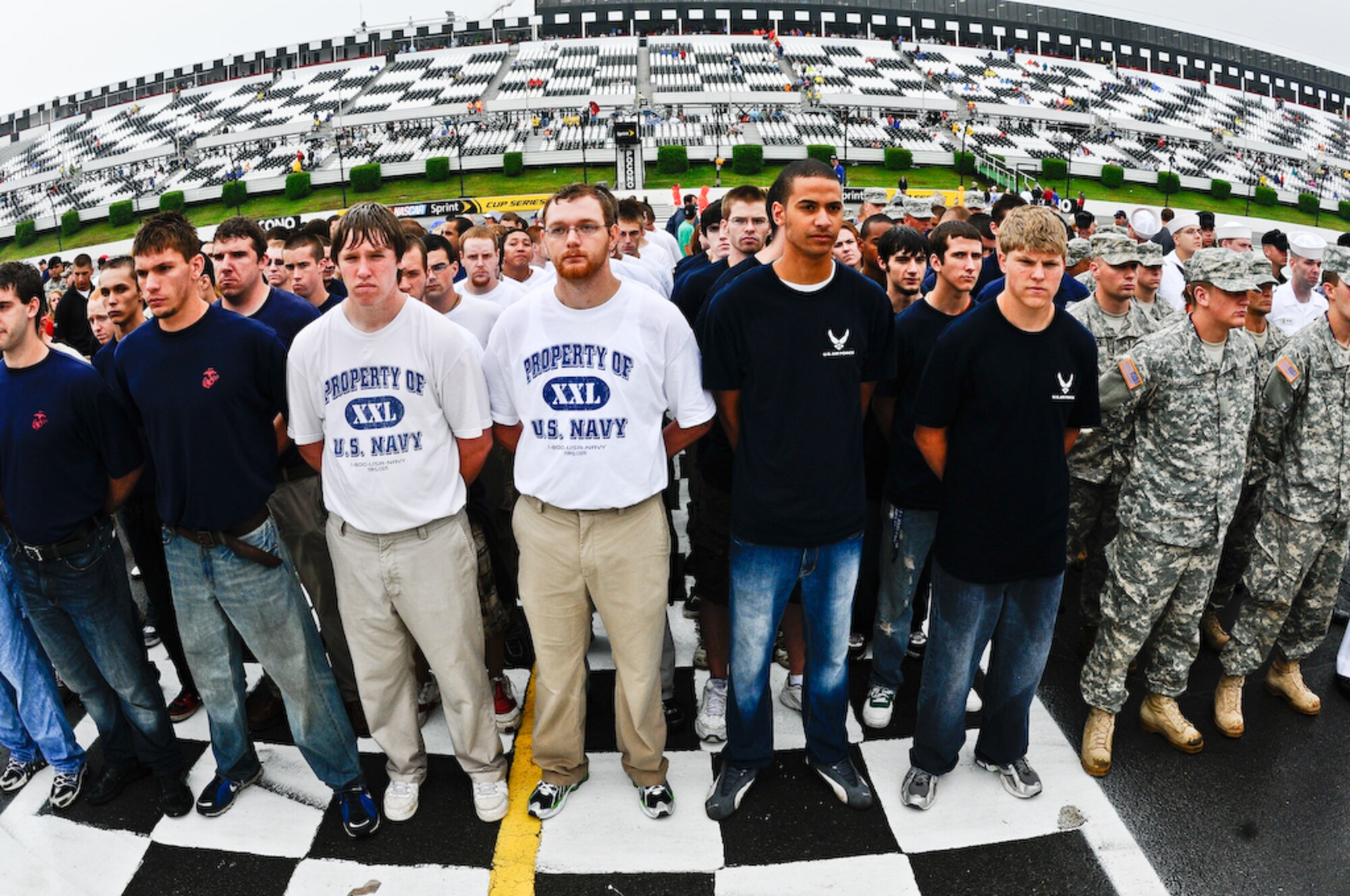 Delayed Enlistment Program members from all services stand-by to be sworn in by Gen. Norton A. Schwartz, Chief of Staff of the Air Force, inside the Pocono Motor Raceway Aug. 2 in Pocono, Pa. The DEP is a reserved slot for individuals joining the military as an inactive reserve prior to their set departure date for basic military training. There were more than 100 DEP members from all branches of service, with 23 joining the U.S. Air Force family. (U.S. Air Force photo by Senior Airman Alexandre Montes)