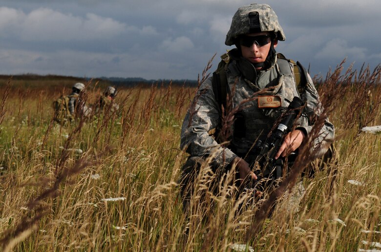 U.S. Air Force Airman 1st Class Matthew Aguirre, a Tactical Air Control Party, ROMAD, from the 1st Air Support Operations Squadron, secures position of team mates during Allied Strike, Grafenwoehr, Germany, Aug. 3, 2009.  Allied Strike a service, multi-national exercise presents realistic scenarios for participants to hone skills before deploying. (U.S. Air Force photo by Staff Sgt. Jocelyn Rich)