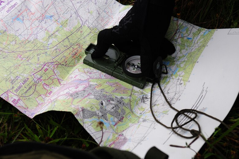 U.S. Air Force Staff Sgt. Weldon Leonard, a Tactical Air Control Party member from the 1st Air Support Operations Squadron, navigates the terrain with a map and compass, when his GPS was simulated destroyed at Allied Strike, Grafenwoehr, Germany, Aug. 3, 2009. Allied Strike a service, multi-national exercise presents realistic scenarios for participants to hone skills before deploying. (U.S. Air Force photo by Staff Sgt. Jocelyn Rich)