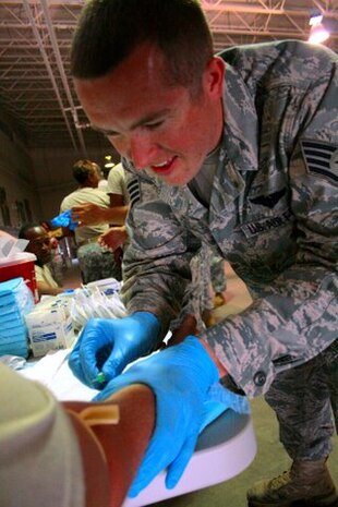Staff Sgt. David Simmons prepares to insert his first intravenous catheter during the Army's Combat Life Saver Course at the North Charleston National Guard Armory recently. Sergeant Simmons was the first Airman from Charleston AFB to attend the CLS course and will be transitioning to become a door gunner on an Air Force HH-60 Pavek Hawk. Sergeant Simmons is assigned to the 437th Aerial Port Squadron. (U.S. Army photo/Spc. Joshua Edwards)