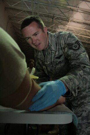 Staff Sgt. David Simmons prepares to insert his first intravenous catheter during the Army's Combat Life Saver Course at the North Charleston National Guard Armory recently. All students in the course must be able to successfully start an IV catheter on another student. Sergeant Simmons is assigned to the 437th Aerial Port Squadron. (U.S. Army photo/Spc. Joshua Edwards)