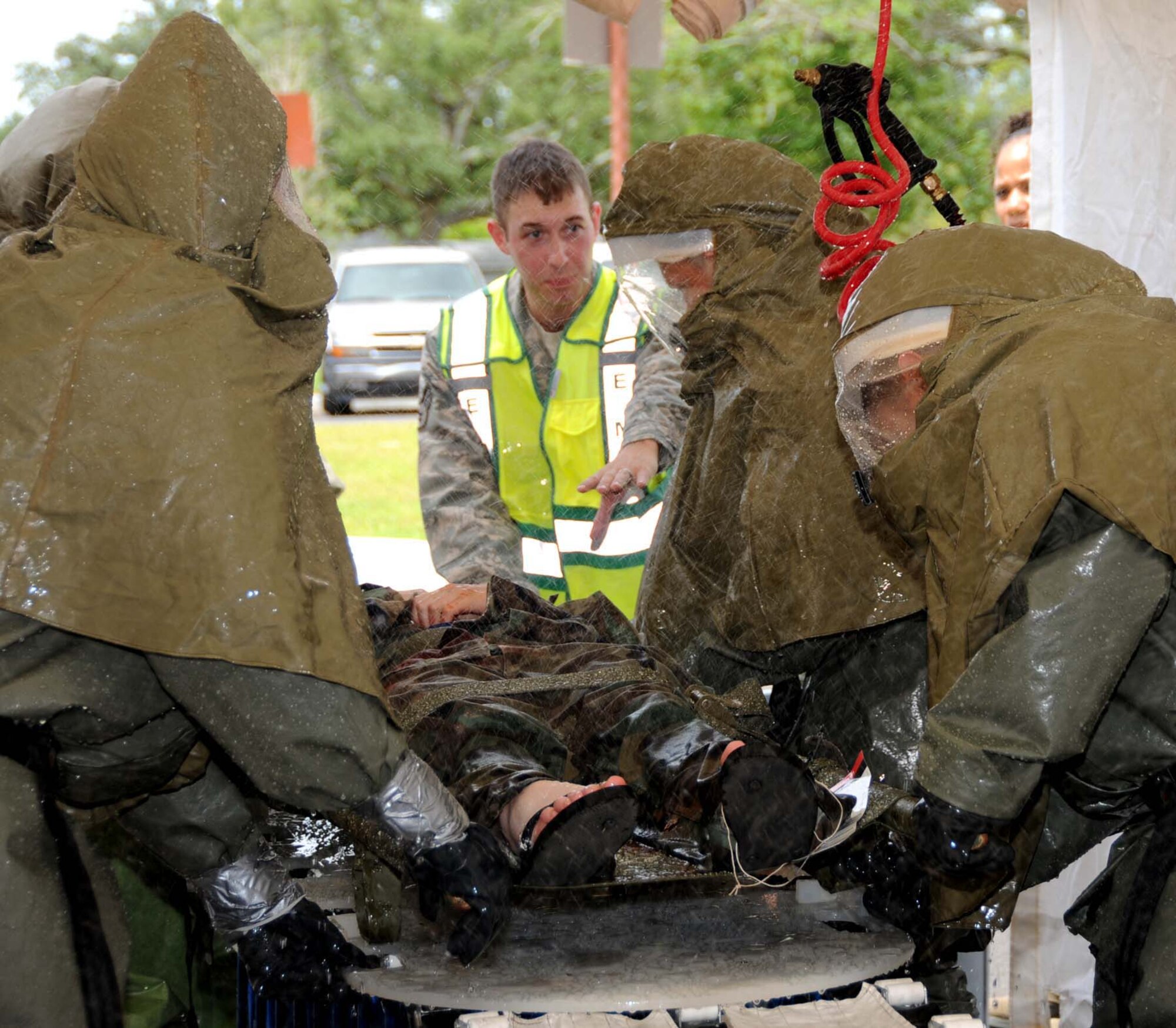 Senior Airman Jamie Whitten, 81st Aerospace Medicine Squadron, briefs the decontamination team about Airman Wilson’s condition.    The exercise tested also the 81st Medical Group’s immediate medical response capability, bioenvironmental response to a potential chemical agent, laboratory response network procedures for analyzing an unknown “white powder” and the installation’s disease containment plan.  Program objectives were to educate senior bae leaders, provide exercise evaluation team training and validate emergency response operations.   (U.S. Air Force photo by Kemberly Groue)