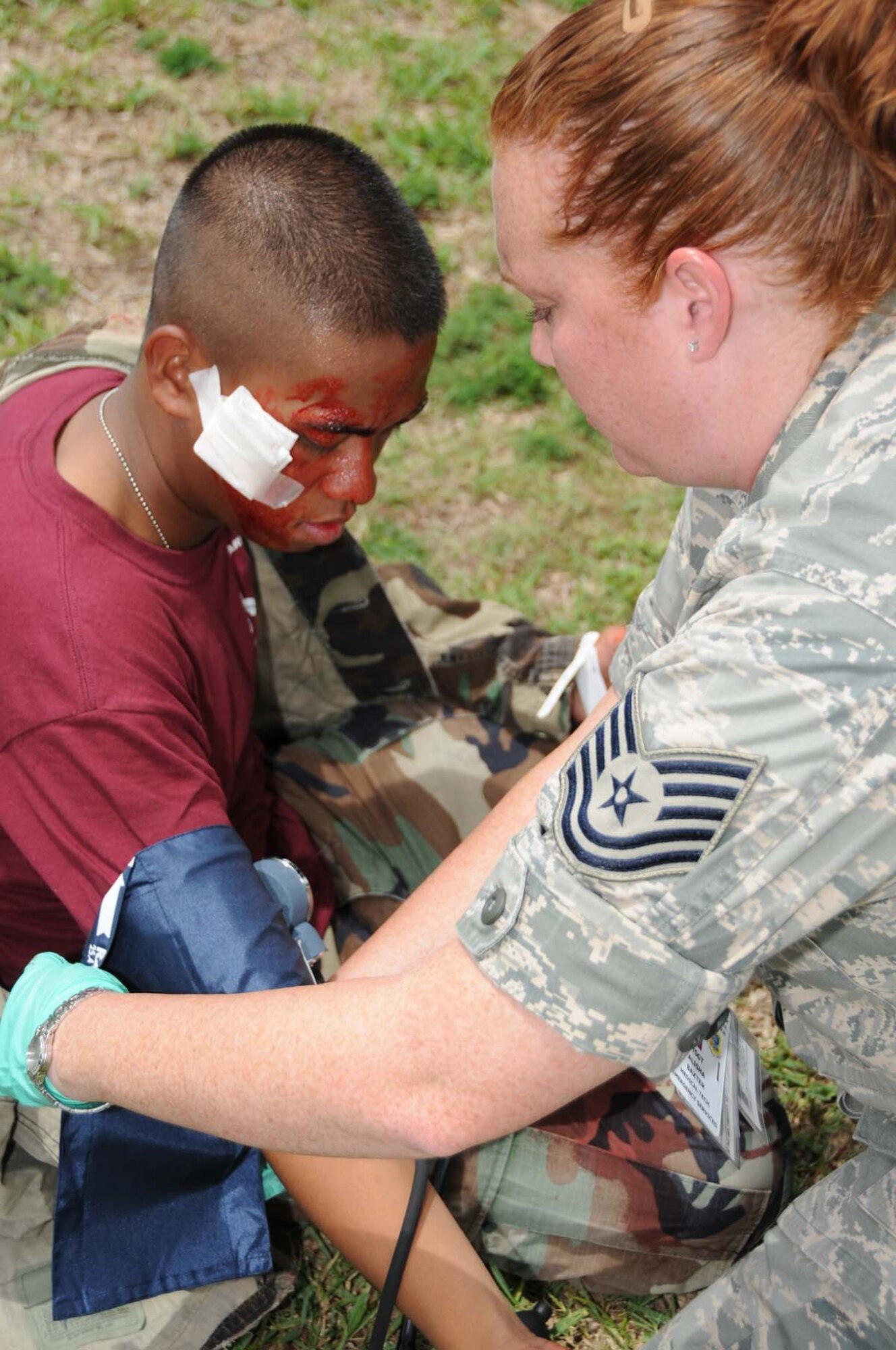 Airman Basic John Rey Andres, 336th TRS student, has his vital signs checked after his “wounds” were bandaged by Tech. Sgt. Alisha Baxter, 81st MDOS.  (U.S. Air Force photo by Kemberly Groue)