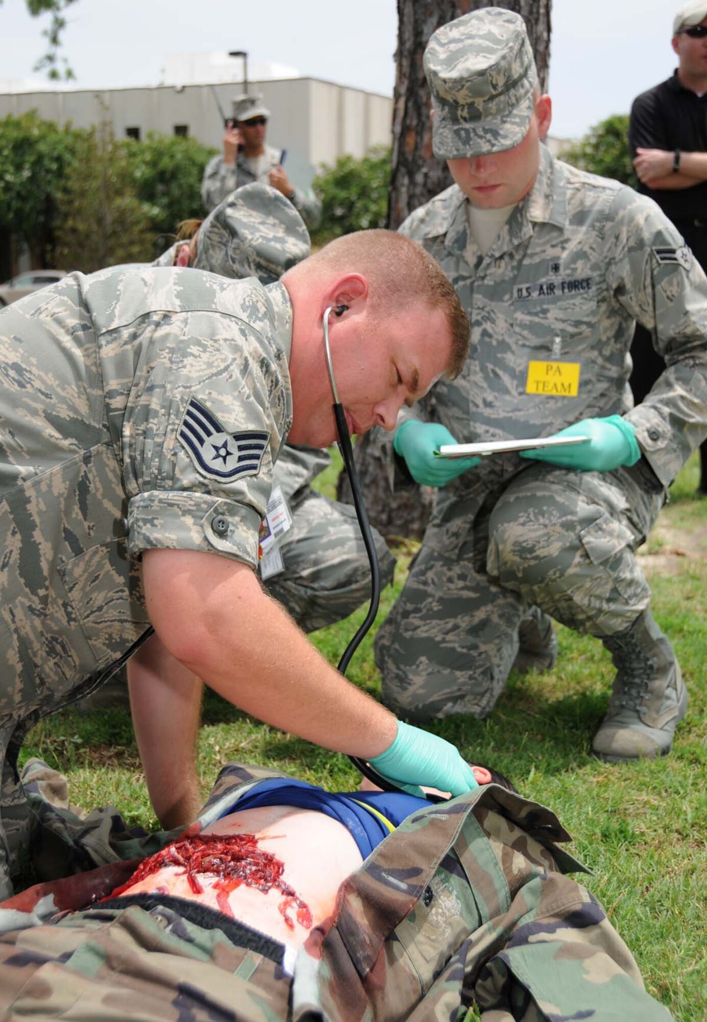 Staff Sgt. James Clark, 81st MDOS, cares for Airman Basic Kelli Wilson, 336th TRS student, documents treatment in her patient tracking folder.  (U.S. Air Force photo by Kemberly Groue)
