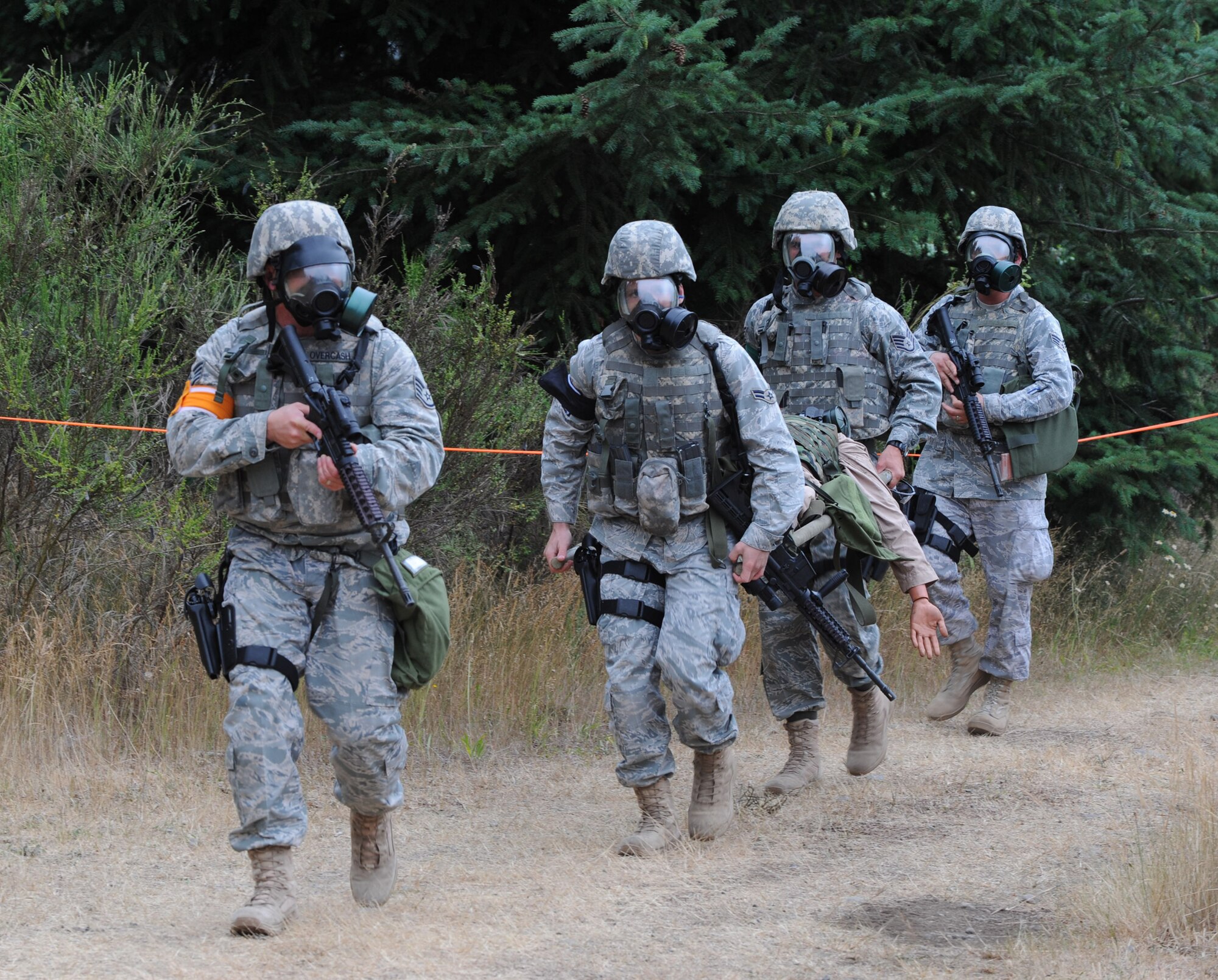Members from Team McConnell?s RODEO security forces evacuate a simulated casualty during a combat weapons competition at McChord Air Force Base, Wash., on July 22. Senior Airman Nathan Shelley, a Reservist assigned to the 931st Air Refueling Group, was part of the security team. Reservists and active-duty Airmen represented McConnell as a total-force RODEO team for the first time. (U.S. Air Force photo/Tech. Sgt. Chyrece Campbell)