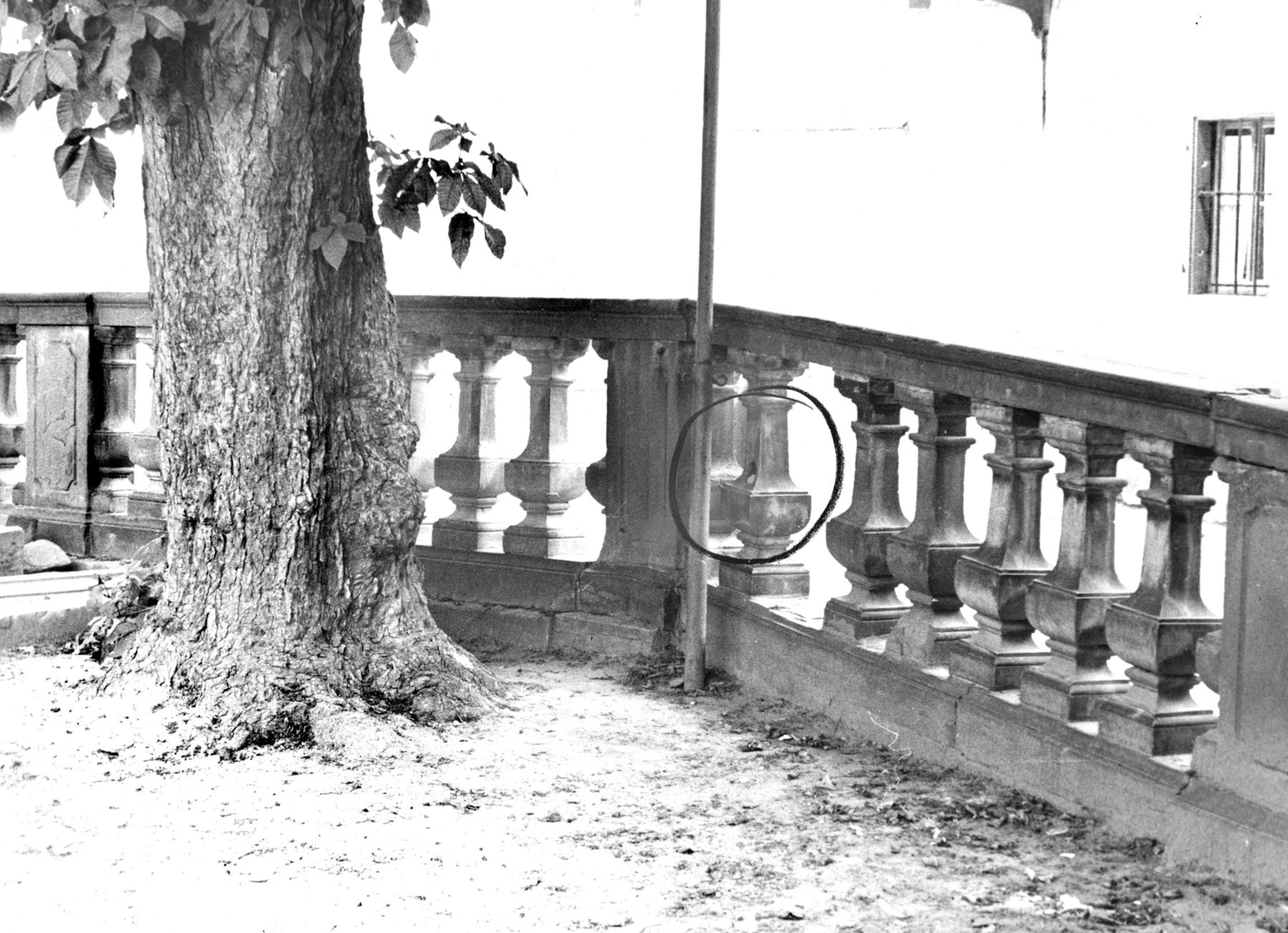 In the late 1950s, a German civilian working at USAF headquarters in Wiesbaden, Germany, photographed classified documents to pass to communist agents. Using a hollow spot in a stone fence (circled in photo) as a “dead drop,” he left film for others to retrieve. OSI watched and photographed the whole process. (U.S. Air Force photo)