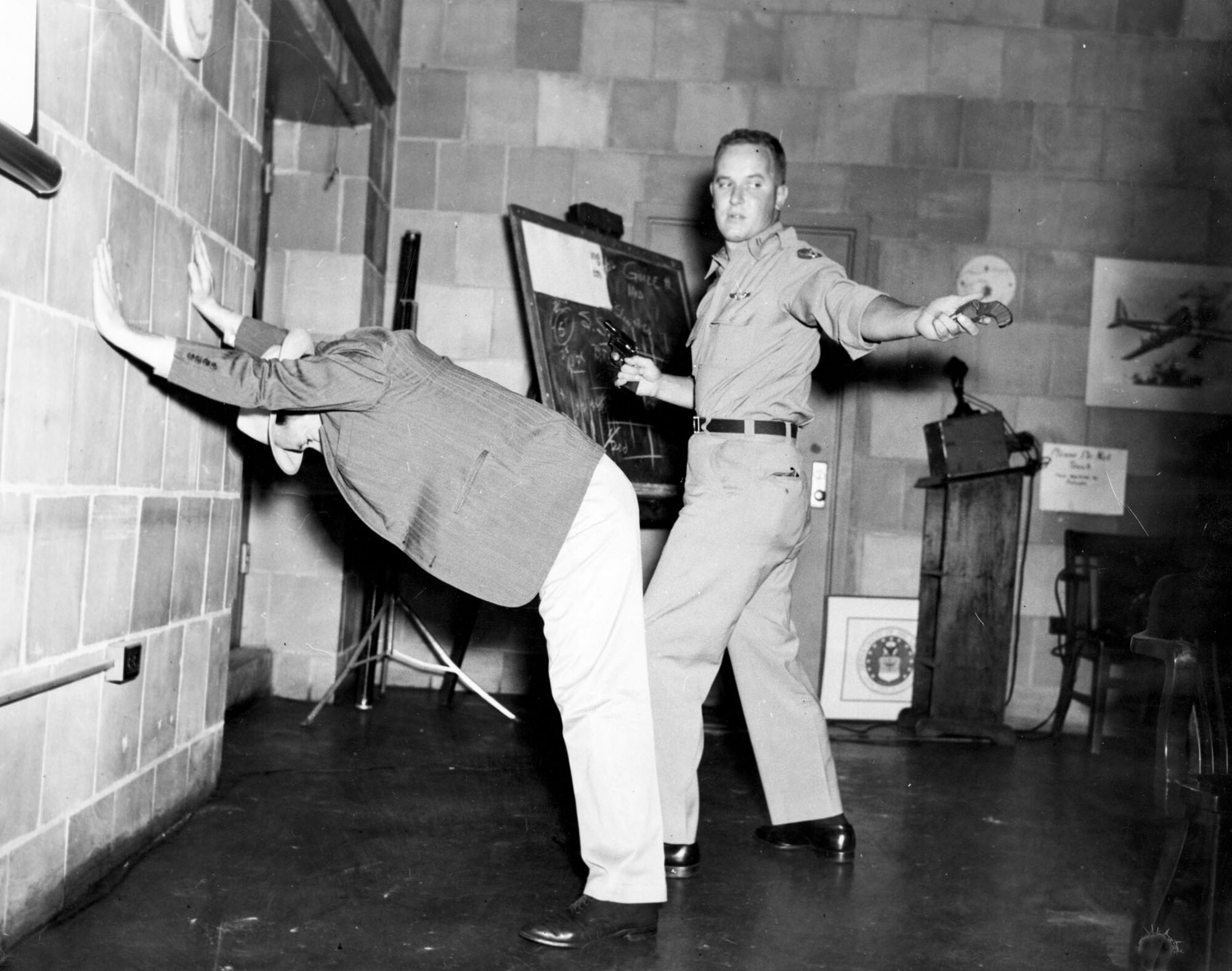 Special Agents must know how to search suspects and use firearms. These training scenes are from 1949 at Fort George Meade, Md. (U.S. Air Force photo)