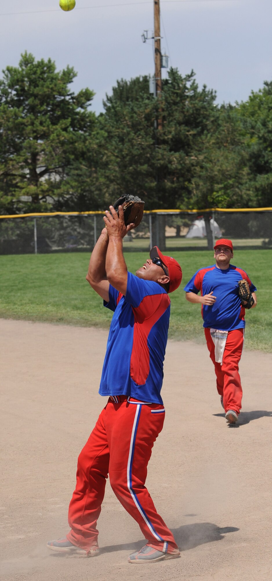 MOUNTAIN HOME AIR FORCE BASE, Idaho-- Sam Pursley, Thrifty's Shake ‘n Bake first baseman, catches a pop fly at first base during the championship game of the Warmheart Tournament Aug 2. Thrifty's Shake ‘n Bake beat Ammo "A" 15-5. The softball tournament, won by Thrifty's Shake ‘n Bake for the third year in a row, kicked off at 3 p.m. July 31 and ran through Aug. 2 with games played 24 hours a day. Operation Warmheart -- run by the first sergeants council and other committee members -- raises funds to help military families when times get tough financially.  (U.S. Air Force photo by Airman 1st Class Renishia Richardson)