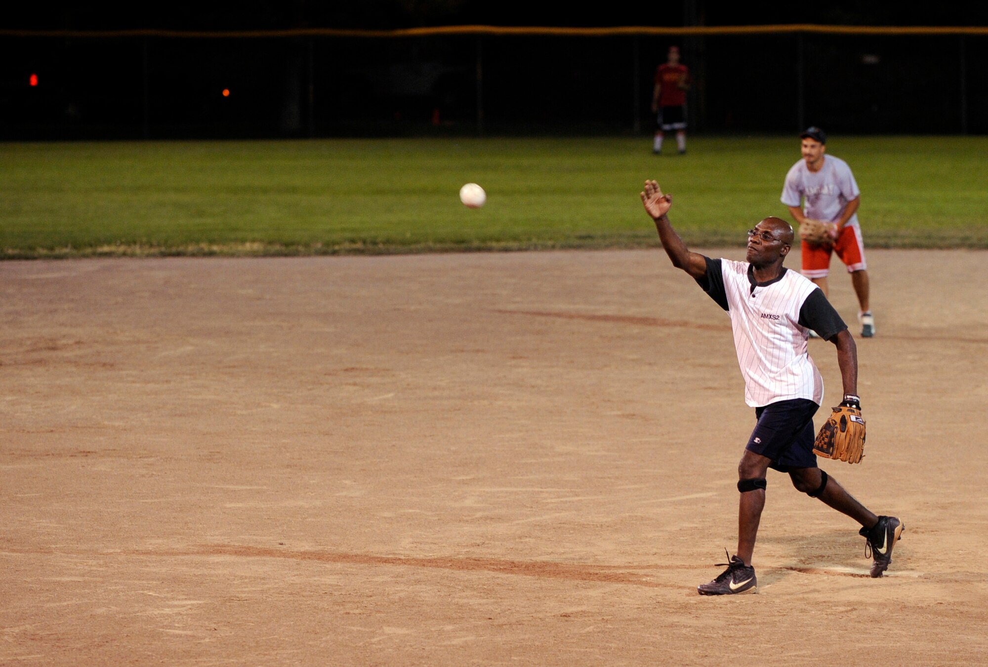 MOUNTAIN HOME AIR FORCE BASE, Idaho -- Gerard Liburd, 366th Aircraft Maintenance Squadron pitcher, throws a strike during an Operation Warmheart softball game July 31. AMXS annihilated CMS 19-3. The softball tournament, won by Thrifty's Shake ‘n Bake for the third year in a row, kicked off at 3 p.m. July 31 and ran through Aug. 2 with games played 24 hours a day. Operation Warmheart -- run by the first sergeants council and other committee members -- raises funds to help military families when times get tough financially. (U.S. Air Force photo by Airman 1st Class Debbie Lockhart)
