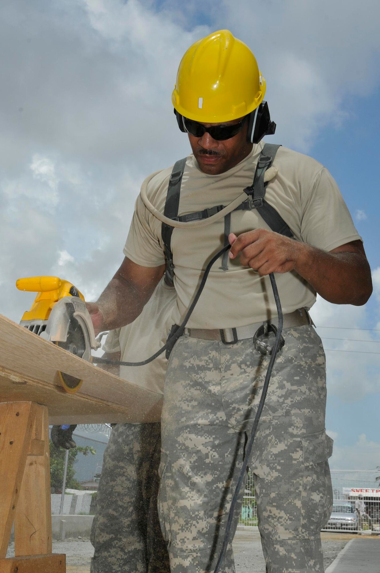 Staff Sgt Roenzer Branson, a engineering technician from the 878th Engineer Battalion, Georgia Army National Guard, cuts a sheet of plywood for the walls inside the new medical clinic being constructed July 3, 2009 in Georgetown, Guyana. Soldiers from the Georgia Army National Guard are building the $350,000 clinic, which will feature four examination rooms, an office, waiting room and bathroom. (U.S. Air Force photo by Airman 1st Class Perry Aston) (Released)