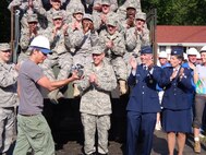 Ty Pennington, star of the ABC series 'Extreme Makeover: Home Edition", used
his "Ty Cam" to interview members of the Air Force team that helped demolish
the family's old home Saturday morning.  At right are Gen. Donald Hoffman,
Lt. Gen Jack Hudson and retired Col. Sue Busler.  
(Air Force photo by Ron Fry)
