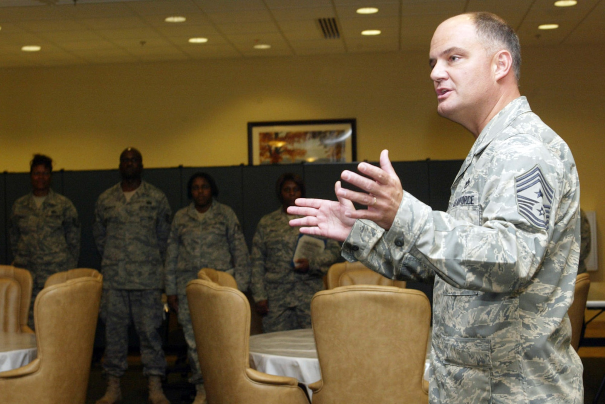 DOBBINS AIR RESERVE BASE, Ga. -- Command Chief Master Sgt. Dwight D. Badgett, Air Force Reserve Command command chief, congratulates and passes on words of encouragement to graduates of the recent Non-Commissioned Officer Leadership and Development Course at a recognition ceremony at the consolidated club here July 31. During his immersion of the units and people of Dobbins ARB, the Chief spoke about common concerns shared by reservists and listened to questions and comments Airmen had. (Air Force photo/Don Peek)

