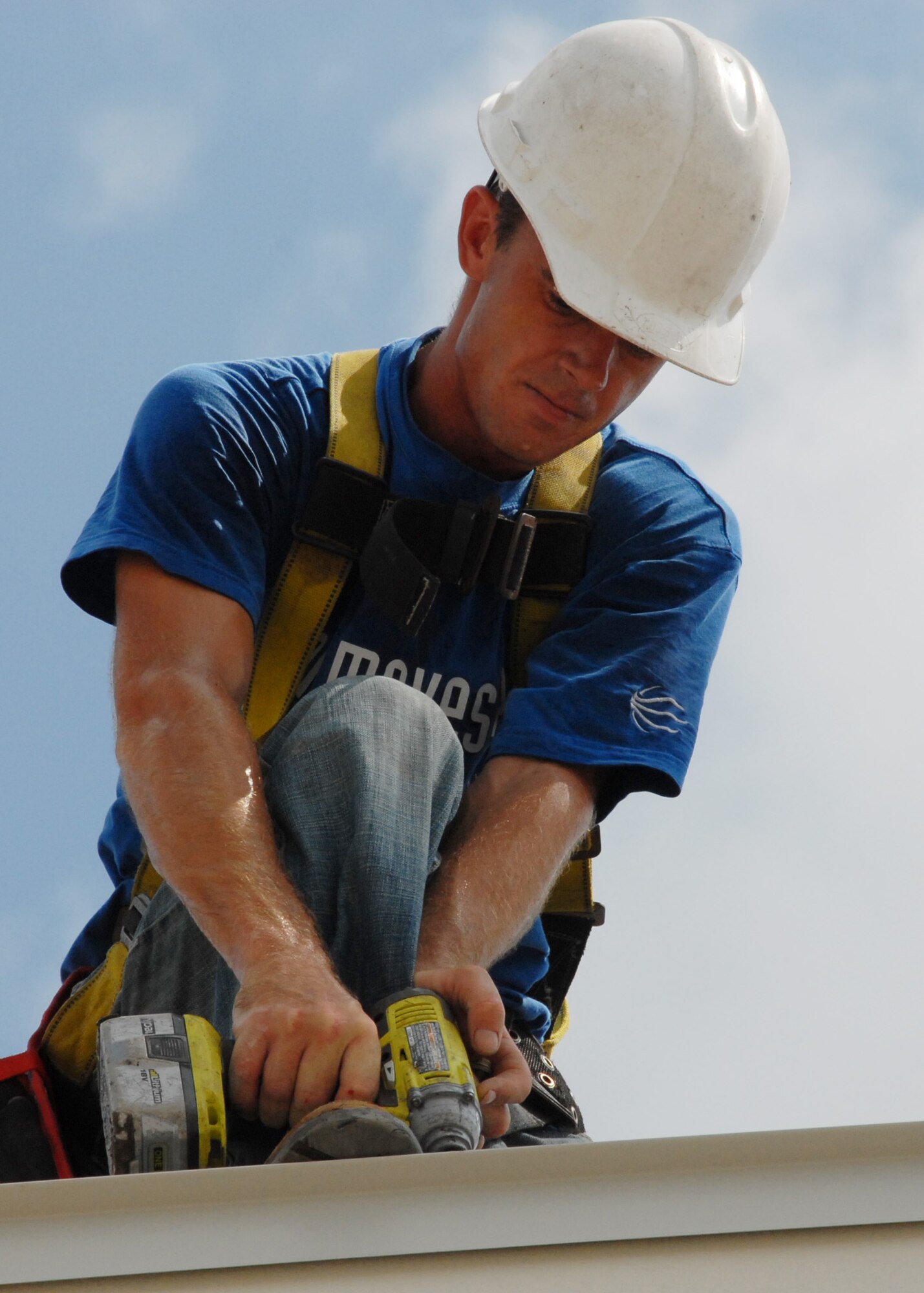Anthony McClure, R.L. Campbell Construction, drills down a panel to the corner of the roof of the 919th Logistics Readiness hangar Aug. 3 at Duke Field.  This is just one of many construction projects taking place at Duke Field.    (U.S. Air Force photo/Staff Sgt. Samuel King Jr.)