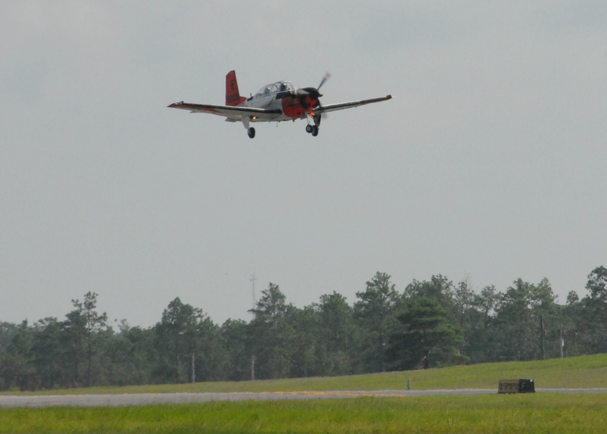 A Naval T-34 Turbo Mentor, performs a touch-n-go procedure over the Duke Field runway Aug. 3.  The training aircraft is used at NAS Whiting Field, but occasionally performs approaches here.  NAS Whiting Field also provides training for U.S. Marine Corps, Coast Guard, and Air Force student pilots, as well as several allied nations.  (U.S. Air Force photo/Staff Sgt. Samuel King Jr.)
