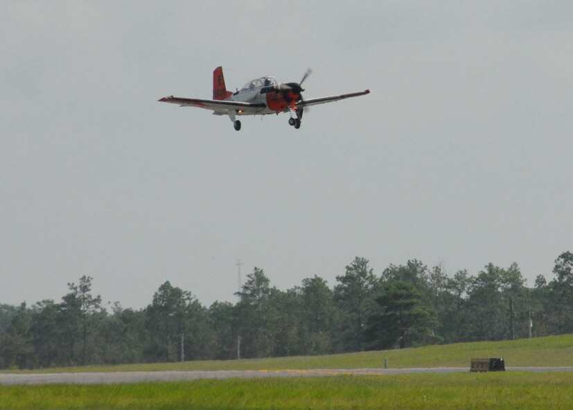 A Naval T-34 Turbo Mentor, performs a touch-n-go procedure over the Duke Field runway Aug. 3.  The training aircraft is used at NAS Whiting Field, but occasionally performs approaches here.  NAS Whiting Field also provides training for U.S. Marine Corps, Coast Guard, and Air Force student pilots, as well as several allied nations.  (U.S. Air Force photo/Staff Sgt. Samuel King Jr.)
