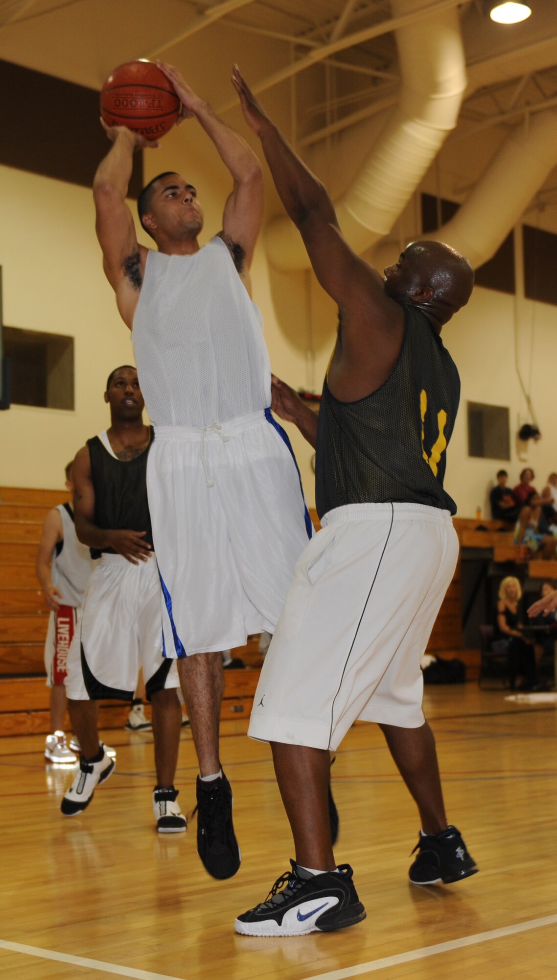 MOUNTAIN HOME AIR FORCE BASE, Idaho-- Patrick McIntyre, The Hawks, shoots over a defender during a base summer league basketball game at the Gunfighter Fitness Center July 28.  The Underdogs beat the Hawks 64-48. (U.S. Air Force photo by Airman 1st Class Renishia Richardson)
