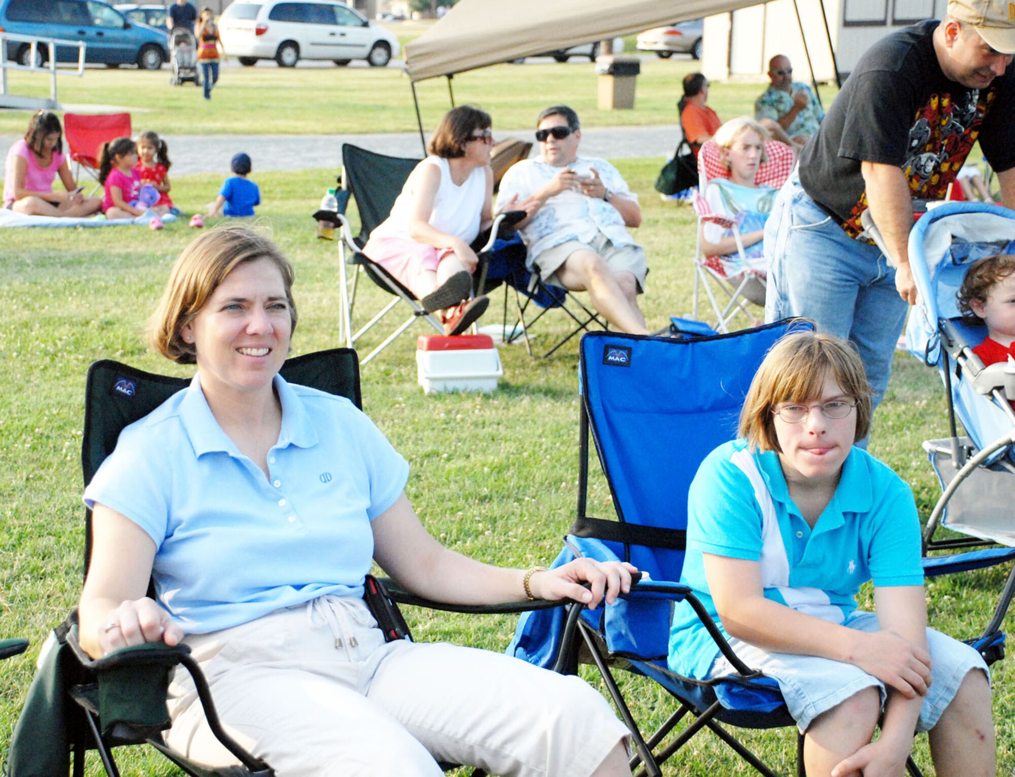 (Left to right) Maj. Teresa Darrow, 436th Force Support Squadron commander, and daughter Jordan, watch The Fe Band during 'A Night of Island Music,' an event sponsored by the 436th FSS to promote morale and family bonding July 24 at Eagle Heights. (U.S. Air Force photo/Airman 1st Class Matthew Hubby)