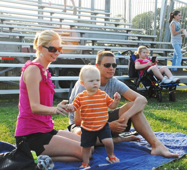 (Left to right) Sarah Dressler, Capt. Judson Dressler, 436th Communications Squadron plans and implementations flight commander, and their son, David, watch The Fe Band play Caribbean music during 'A Night of Island Music,' an event sponsored by the 436th Force Support Squadron July 24 at Eagle Heights. (U.S. Air Force photo/Airman 1st Class Matthew Hubby)