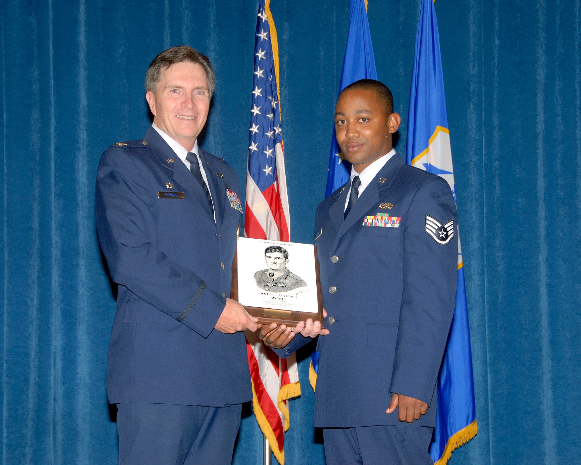 McGHEE TYSON AIR NATIONAL GUARD BASE, Tenn. - Staff Sgt. Telshaun M. Davis,
an avionics systems journeyman, from the 172nd Airlift Wing in Jackson,
Miss., receives the John L. Levitow Award from Col. Richard B. Howard,
commander of the I.G. Brown Air National Guard Training and Education Center
during the graduation ceremony of the Paul H. Lankford Enlisted Professional
Military Education Center's Airman Leadership School Class 09-4, July 30,
2009. (U.S. Air Force photo by Master Sgt. Kurt Skoglund)(Released)