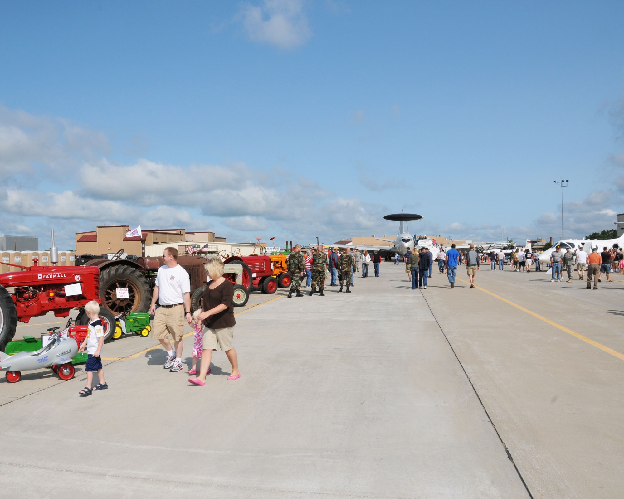 Tractors were on display beside various aircraft filling the ramp at the Sioux Gateway Airport / Col. Bud Day Field, in Sioux City, Iowa, as a B25 flies overhead.  This was all a part of the unique Air & Ag Expo hosted by the 185th Air Refueling Wing.
Official Air Force Photo by: MSgt. Bill Wiseman (released)