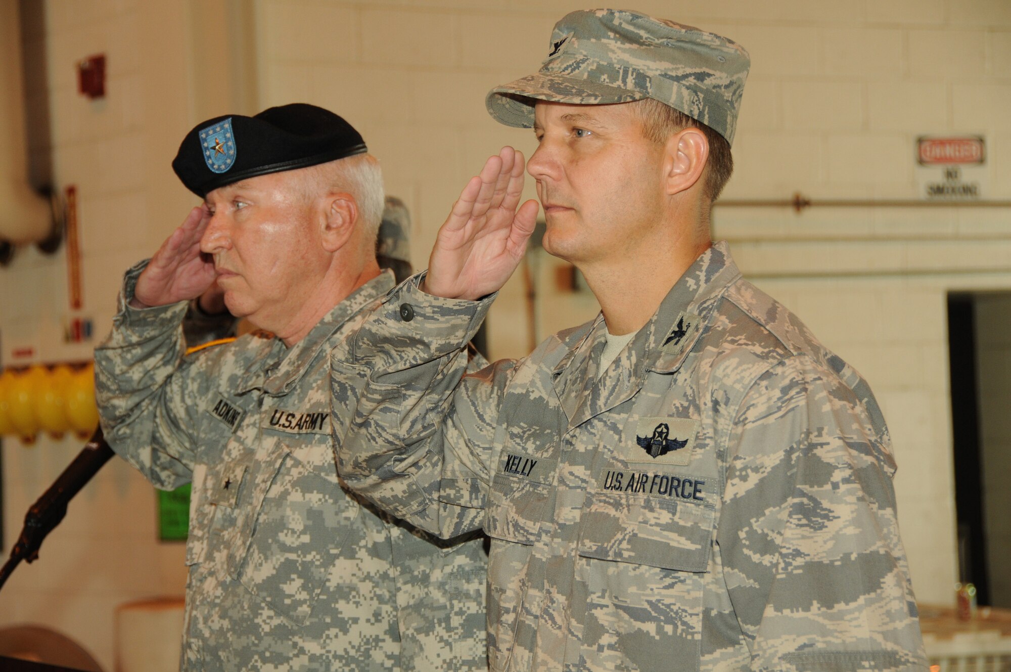 Brig. Gen. James A. Adkins, adjutant general of the Maryland National Guard, and Col. Scott L. Kelly, commander of the 175th Wing, Maryland Air National Guard, salute the flag during the playing of the national anthem during the wing assumption of command ceremony held at the Warfield Air National Guard Base on August 1, 2009.  (U.S. Air Force photo by TSgt. Chris Schepers/Released, 175th Wing/Public Affairs, WARFIELD AIR NATIONAL GUARD BASE, Maryland)