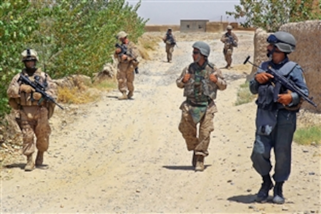 U.S. Marines and Afghan police officers patrol the streets in Helmand province, 
Afghanistan, Aug. 3, 2009. The Marines are assigned to the 2nd Marine Division's Military Police Company, Headquarters Battalion, Regimental Combat Team 3, 2nd Marine Expeditionary Brigade.