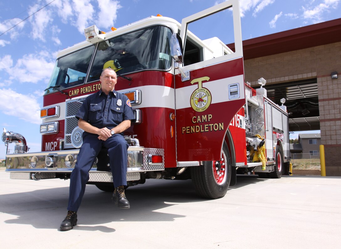 Fire Captain Eric J. McGurn, Camp Pendleton’s Fire and Emergency Services firefighter, sits on the bumper of his fire truck after reflecting on his career. McGurn is slated to retire after 31 years of serving as a firefighter.