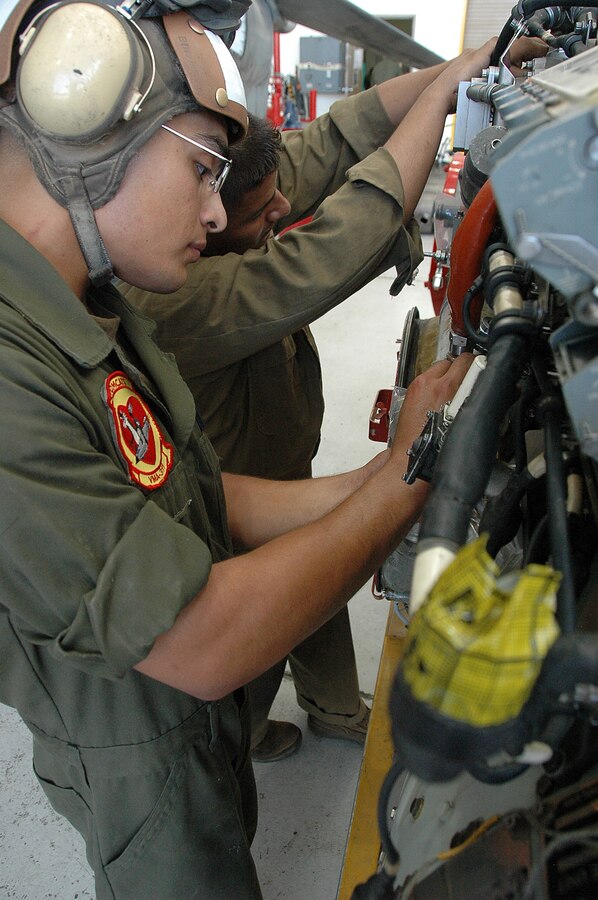 Lance Cpl. Eddie Tapia, left, and Lance Cpl. Manuel GarciaRamirez, Marine Attack Squadron 311 powerline mechanics, prepare an AV-8B Harrier engine to be reinstalled into a Harrier after maintenance in the squadron’s hangar at the Marine Corps Air Station in Yuma, Ariz., Aug. 4, 2009. The squadron was named the attack squadron of the year by the Marine Corps Aviation Association July 28, 2009, for its constant mission readiness and overall performance at home and on deployments. The Tomcats beat out six other squadrons to earn the title, which they have received three times before.