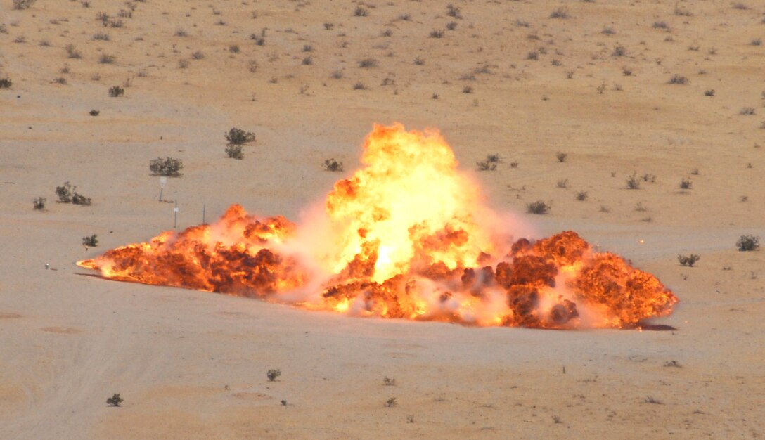A MK-77 fire bomb explodes after being detonated by station explosive ordnance disposal Marines Aug. 4, 2009, at the Barry M. Goldwater Range southeast of the Marine Corps Air Station in Yuma, Ariz. The EOD team safely diposes of all expired or damaged munitions that become unsafe to use in routine operations or training. EOD technicians dispose of more than 10,000 pounds of ordnance annually and support local law enforcement with explosive ordnance disposal. They also conducts range sweeps after the Weapons and Tactics Instructor courses and train extensively for defusing explosives and disposing of unexploded ordnance.