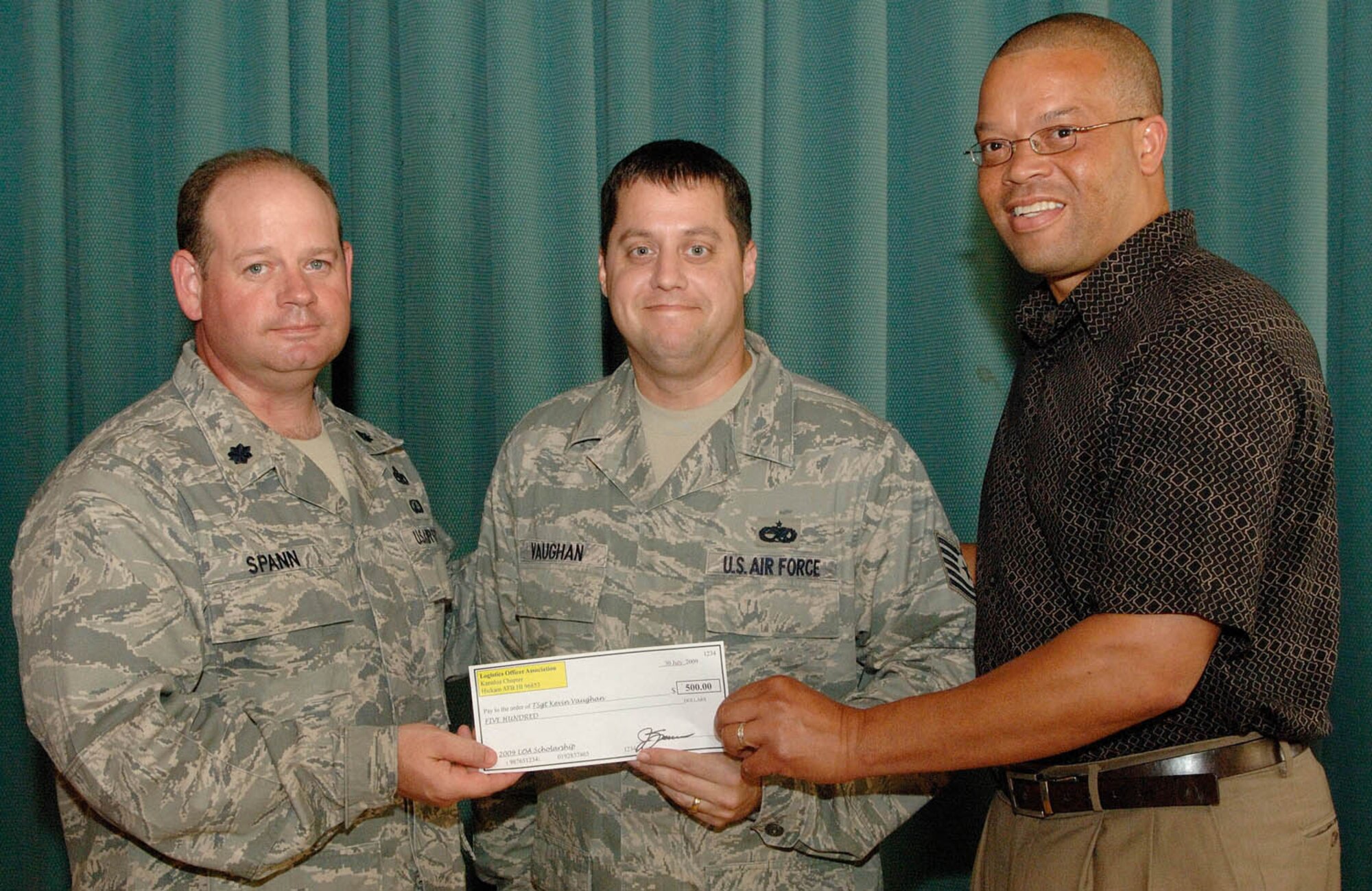 HICKAM AIR FORCEA BASE, Hawaii -- In partnership with Boeing, the Kanaloa Logistics Officer Association at Hickam AFB awarded $1,000 in scholarships July 30.  The local scholarship program is designed specifically for personnel in logistics specialties who are working towards a college degree and  possess the
ambition to improve logistics.  This year's award recipients, Tech. Sgt. Kevin Vaughan, 15th Maintenance Operations Squadron, and Senior Airman Yommala Xaysanith, 154th Logistics Readiness Squadron but currently working with the 15th MOS, each received a $500 scholarship to defray the costs associated with earning their college educations.  Additionally, Airman Xaysanith will represent the Kanaloa LOA Chapter as she competes for a $2,500 scholarship from the National LOA, which will be awarded at the 2009 Logistics Officer Association Conference in Las Vegas this October. Logistics professionals in the Hickam AFB area who would like to join the
Kanaloa LOA Chapter can do so by contacting Capt. Mark Klohr at 449-6231 or
via email at Mark.Klohr@hickam.af.mil . (U.S. Air Force photo/Mark Bates)
