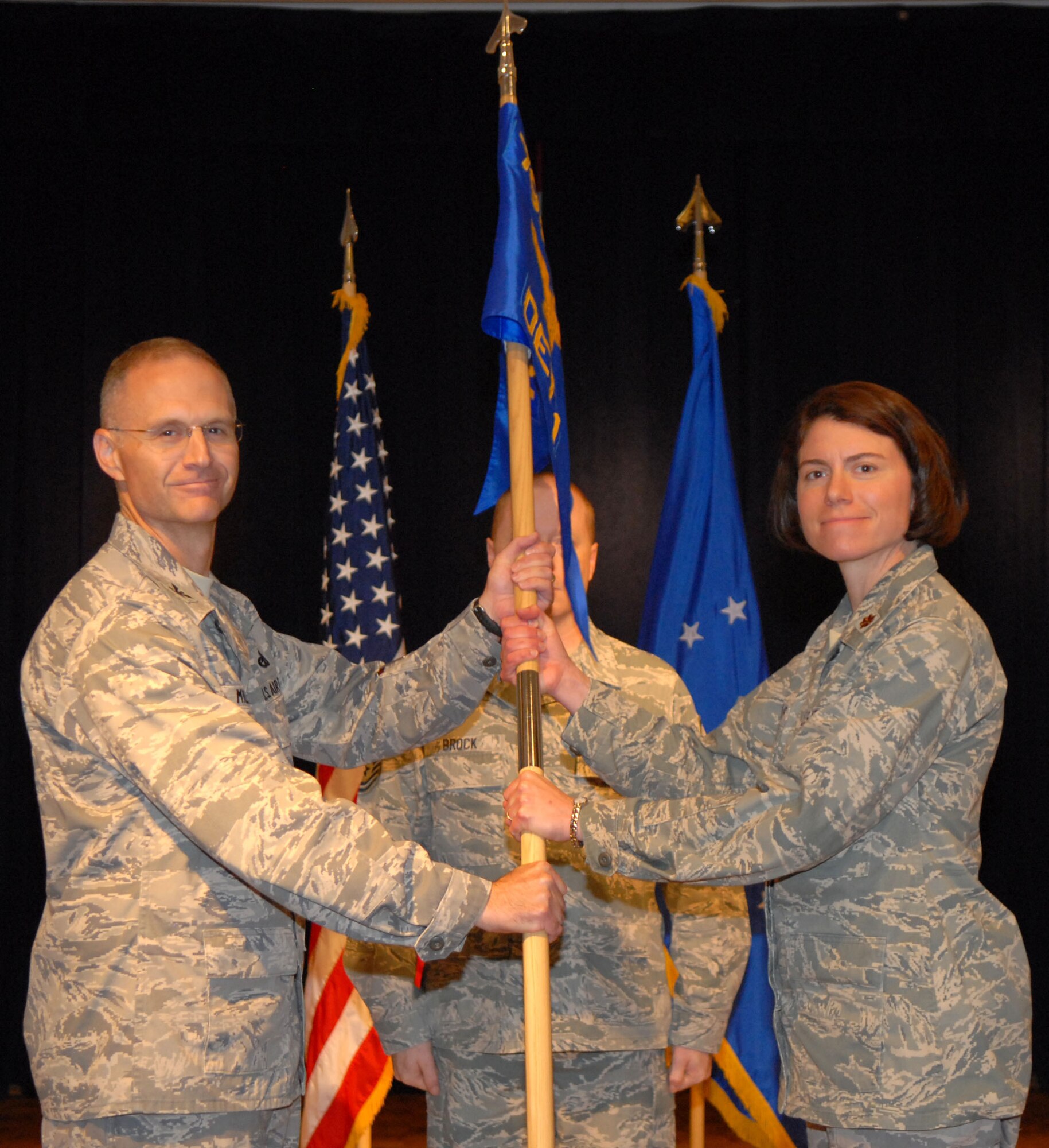 VANDENBERG AIR FORCE BASE, Calif. -- Taking command of the 798th Munitions Maintenance Group, Maj. Margaret Vencius, receives the guidon from Col. David Milner Jr. Aug.5 at the Pacific Coast Club here.(U.S. Air Force photo/Airman 1st Class Kerelin Molina) 