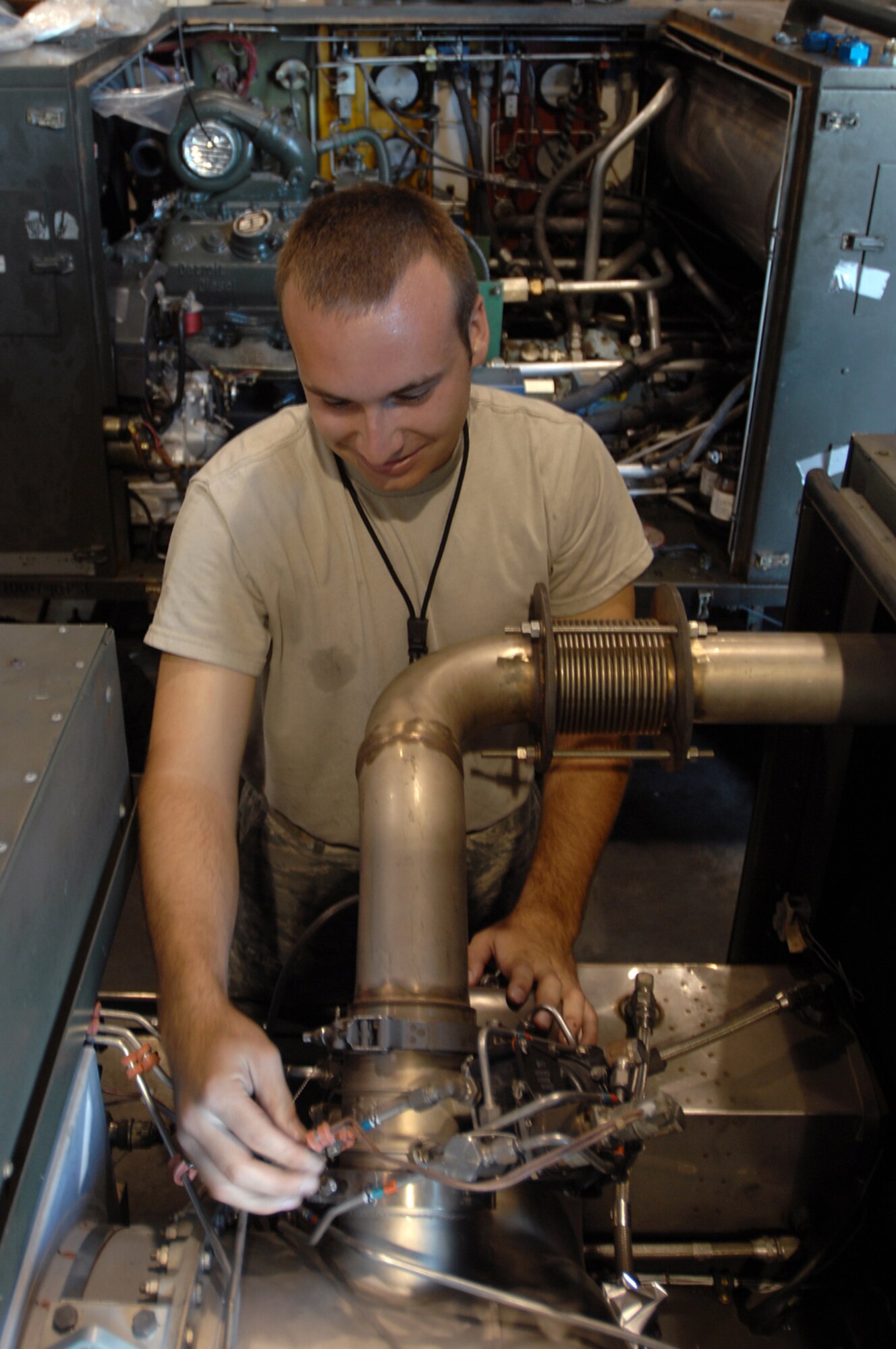 WHITEMAN AIR FORCE BASE, Mo. - Senior Airman Christopher Dewitt, 509th Maintenance Squadron Aerospace Ground Equipment, performs maintenance on a Dash-98, which provides high pressure air to the plan to start the engines. AGE mechanics perform anywhere between 40 to 60 hours of maintenance a week in support of the B-2 mission. (U.S. Air Force photo/Senior Airman Kenny Holston)