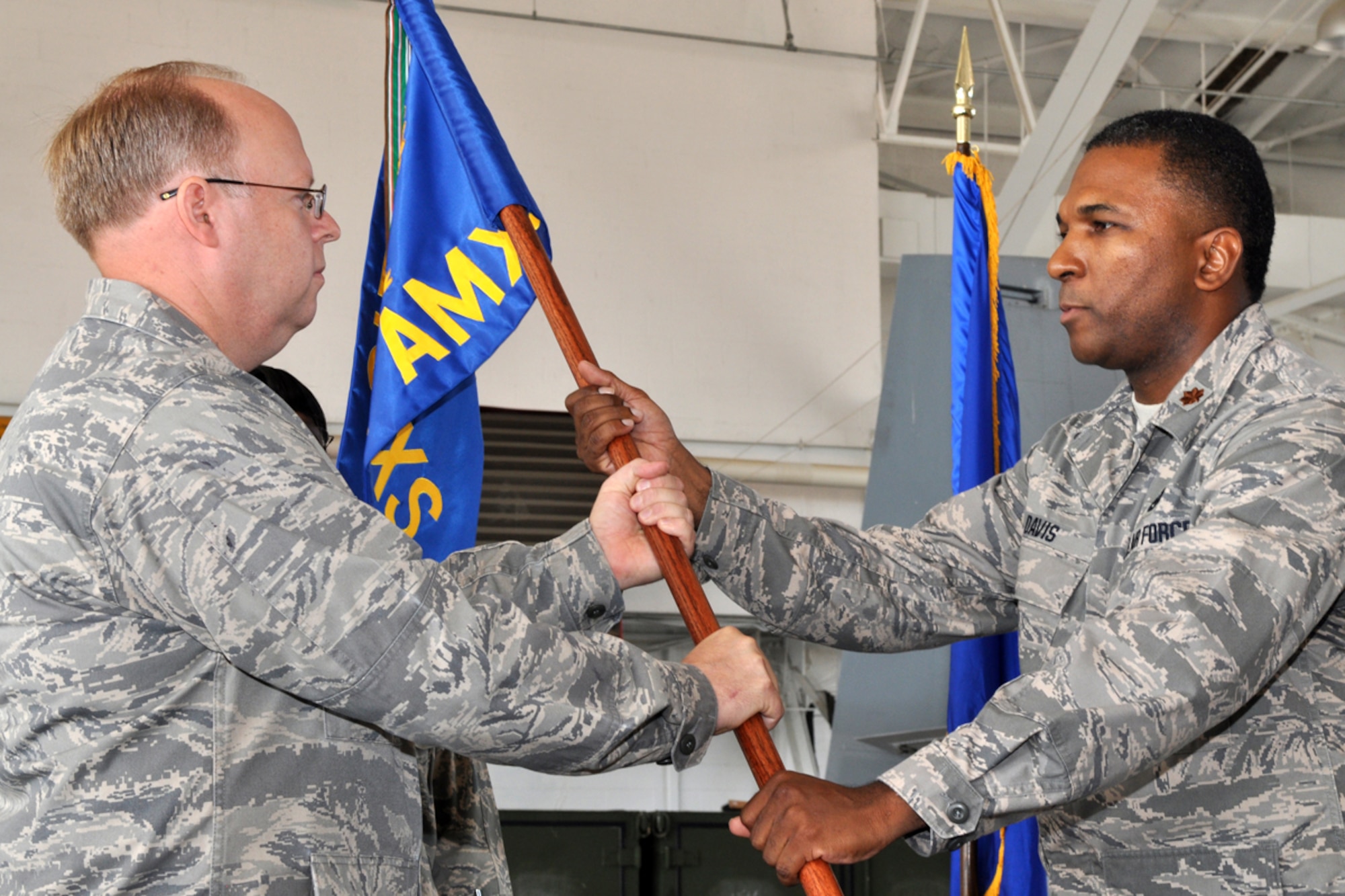 Lt. Col. Jeffrey Mullen, commander, 917th Maintenance Group, passes the guidon and command responsibilities for the 717th Aircraft maintenance Squadron to Maj. Michael R. Davis during a change of command ceremony, Sunday, August 2, 2009, at Barksdale Air Force Base, La.  Maj. Davis took the reins of the 717th AMXS from Lt. Col. Chris Evers. (U.S. Air Force photo/Tech. Sgt. Jeff Walston)