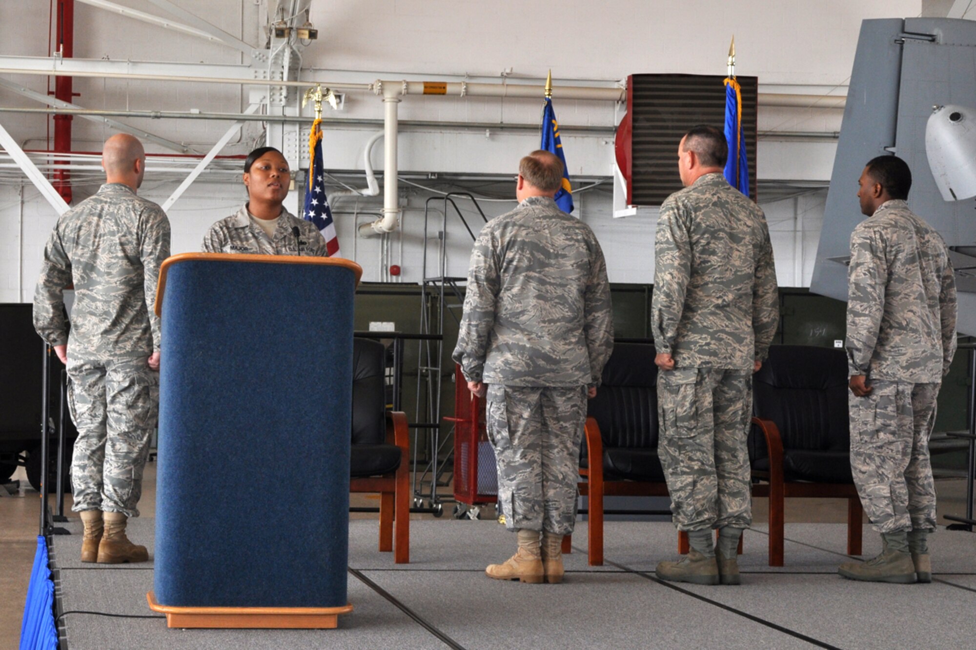 Technical Sgt. Elaine Major, 717th Aircraft Maintenance Squadron, material management clerk, sings the national anthem during the change of command ceremony for the 717th Aircraft Maintenance Squadron, Sunday, August 2, 2009, at the A-10 Hangar on Barksdale Air Force Base, La.  Lt. Col. Chris D. Evers, commander, 717th AMXS, relinquished command to Maj. Michael R Davis during the ceremony. (U.S. Air Force photo/Tech. Sgt. Jeff Walston)