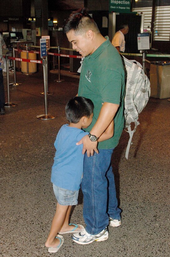 Tech. Sgt. Leonard Samson, 624th Civil Engineer Squadron, receives one last
hug from his son prior to leaving for his deployment at Honolulu
International Airport Friday July 31. Sergeant Samson is one of 54 Reservists
from the 624th CES, which falls under the 624th Regional Support Group, who
are being mobilized to deploy to Afghanistan for six months.  This is a
"partial" mobilization, meaning half the squadron is being mobilized as
opposed to the entire squadron. Once in the AOR, the CE team will be
supporting the Army at Bagram. (U.S. Air Force photo/Mark Bates)