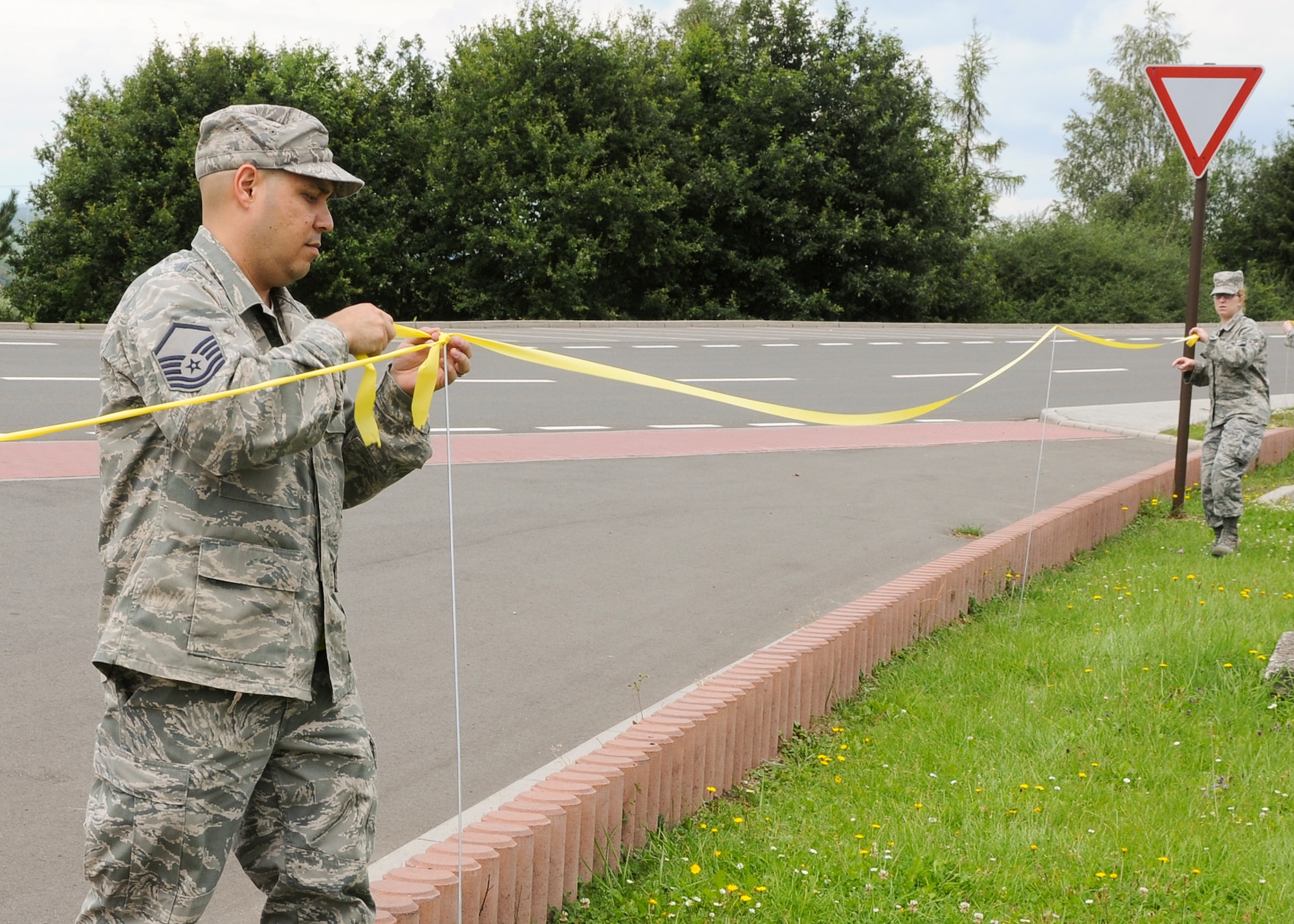 SPANGDAHLEM AIR BASE, Germany -- Master Sgt. Joseph Santiago, 52nd Fighter Wing Plans, Programs and Inspections; and Airman 1st Class Christina Peabody, 52nd Medical Operations Squadron, set the boundaries for the upcoming Phase II exercise Aug. 4-7. The exercise is meant to prepare the 52nd FW for the NATO Tactical Evaluation in 2010. (U.S. Air Force photo by Airman 1st Class Nathanael Callon)