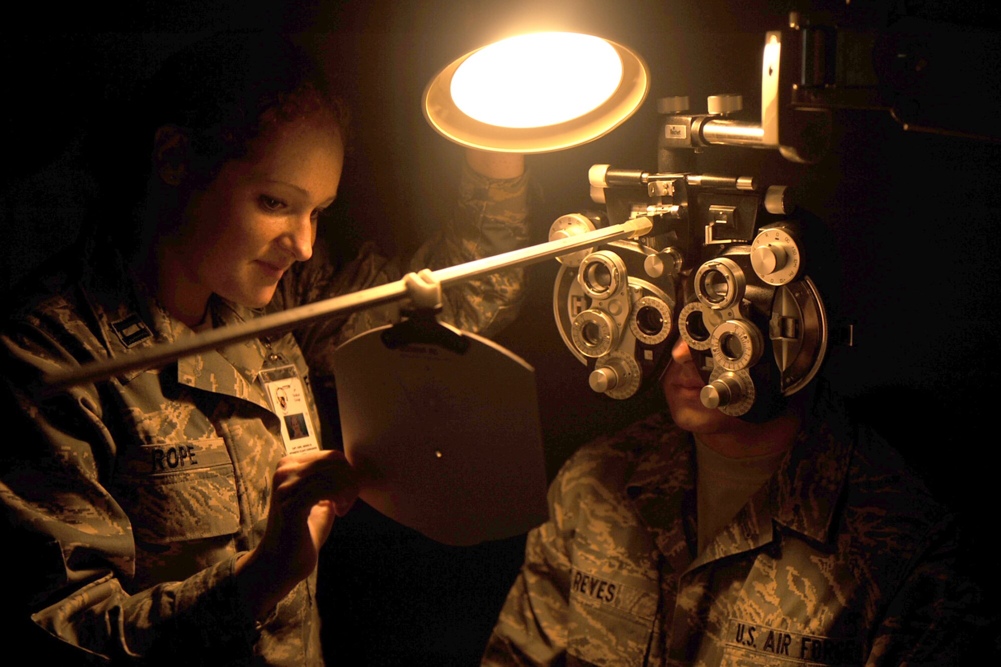 Captain Andrea Rope, 4th Medical Group optometrist, uses a phoropter to check the visual acuity of Airman 1st Class Gino Reyes, 4th Fighter Wing Public Affairs photographer at the optometry clinic on July 31, 2009. Visual acuity is the acuteness of clearness of vision which is dependent on the sharpness of focus within the eye. (U.S. Air Force photo by Senior Airman Ciara Wymbs)
