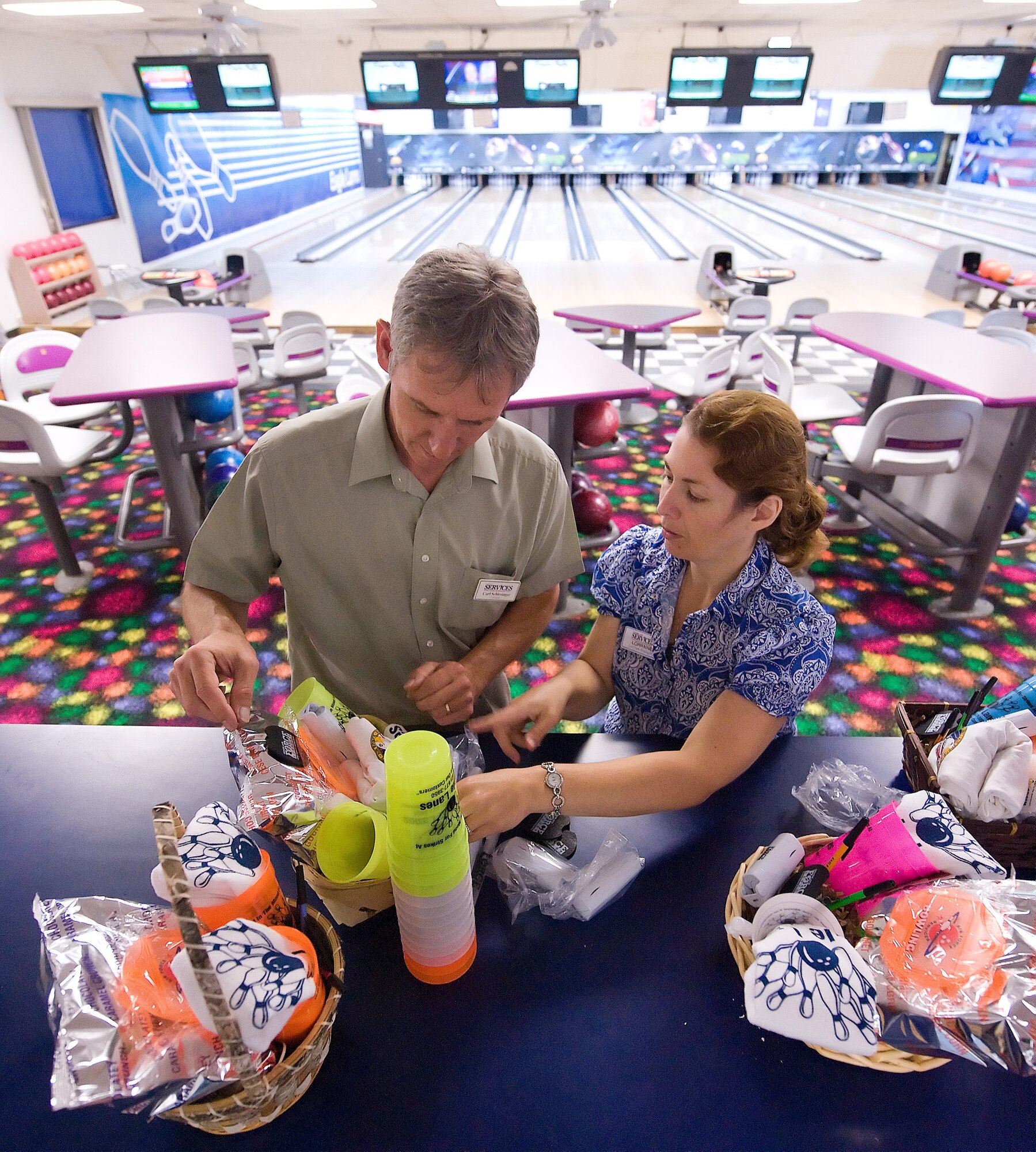 (Left to right) Carl Schlesinger, 436th Force Support Squadron Eagle Lanes Bowling Center manager, and Lorraine Padgett, 436th FSS ELBC assistant manager, make gift baskets July 31. The baskets will be given away during Bowler Appreciation Night scheduled for Aug. 27. (U.S. Air Force photo/Tom Randle)