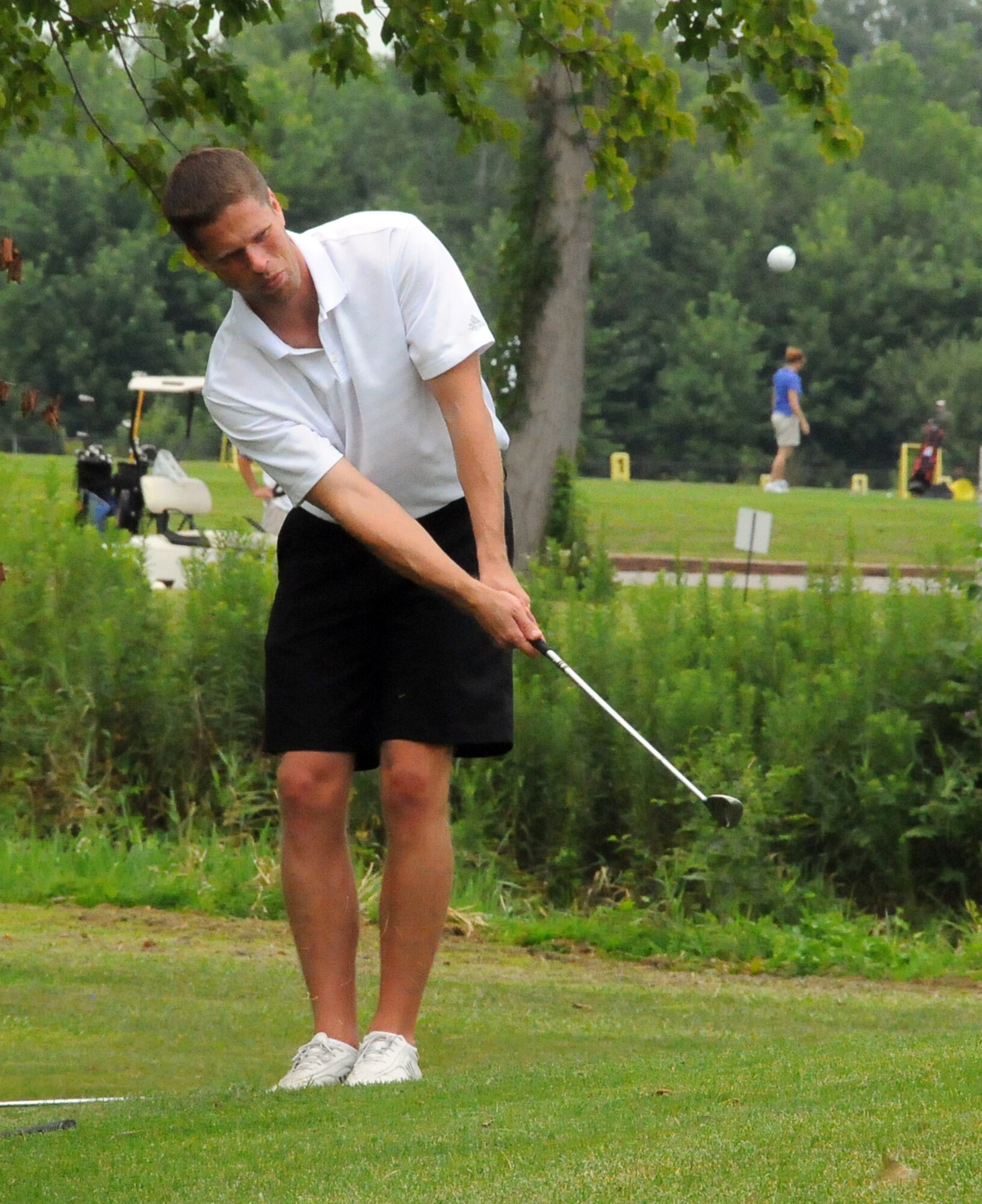 SCOTT AIR FORCE BASE, Ill. -- Navy Petty Officer 2nd Class Joseph Vanhooser chips onto a green during the Navy Ball Golf Tournament July 30 at the Cardinal Creek Golf Course.(Photo courtesy/ Bob Fehringer)