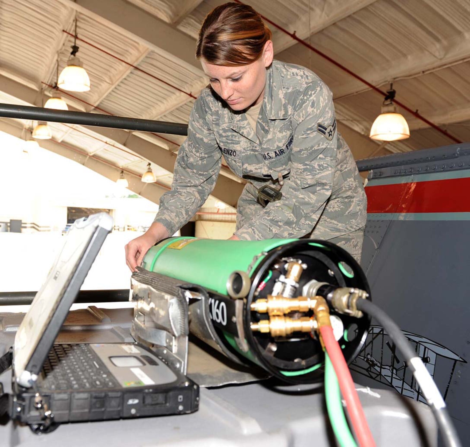 Airman 1st Class Sasha Forlenzo, 4th Equipment Maintenance Squadron non-destructive inspection technician, sets up a focal point for an X-ray on an F-15E Strike Eagle at Seymour Johnson Air Force Base, N.C., July 30, 2009. The X-ray is used to find water entrapped within the metal. On average two jets go through non-destructive inspections a day. (U.S. Air Force photo by Airman 1st Class Gino Reyes)