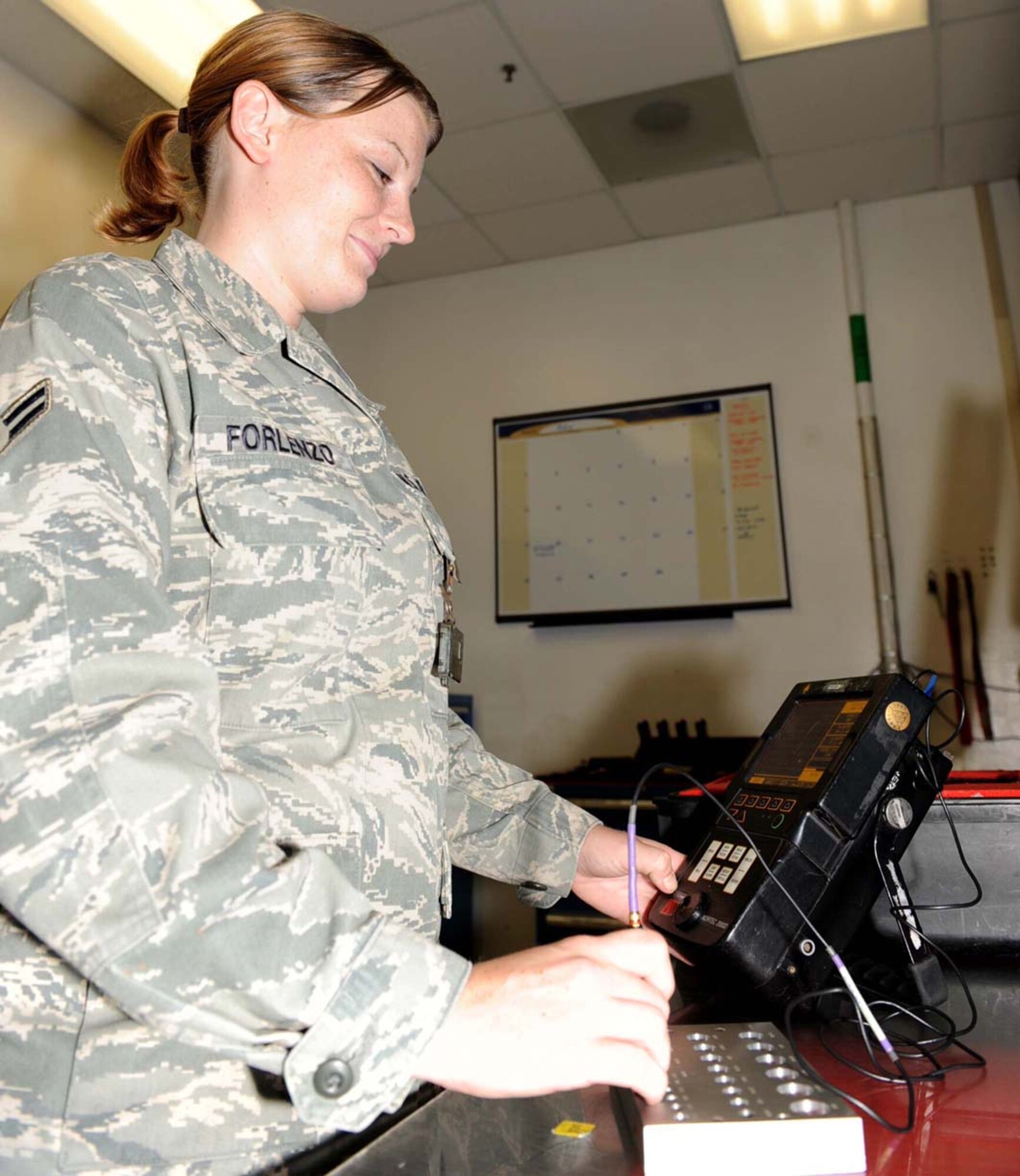 Airman 1st Class Sasha Forlenzo, 4th Equipment Maintenance Squadron non- destructive inspection technician, prepares an Eddy current machine at Seymour Johnson Air Force Base, N.C., July 30, 2009. An Eddy current machine is designed to find cracks in the metal of an F-15E Strike Eagle by sending electric currents through it. (U.S. Air Force photo by Airman 1st Class Gino Reyes)