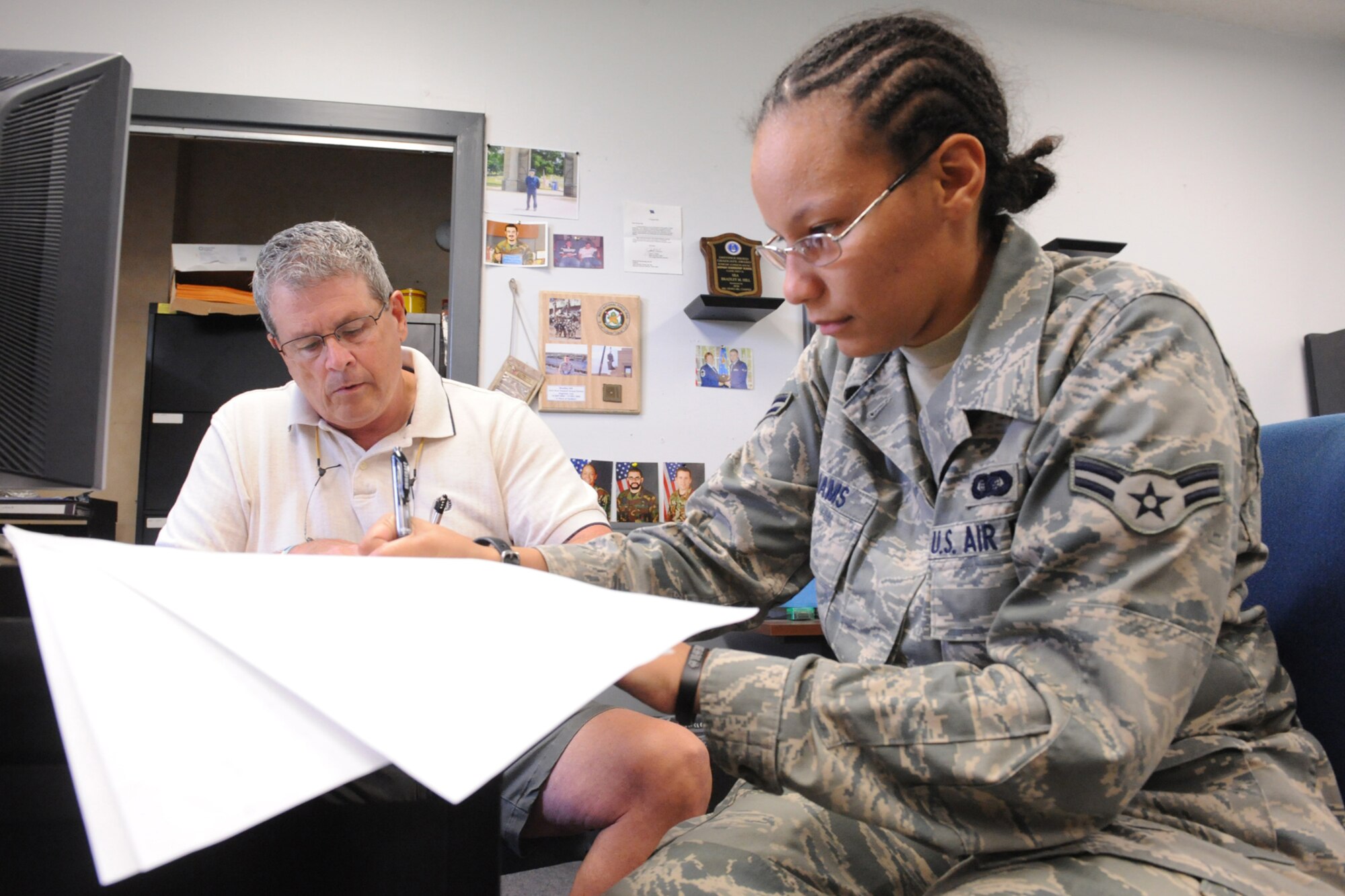 Vic Voorhees, retired Air Force captain, and Airman 1st Class Nasya Williams, 4th Component Maintenance Squadron knowledge operations manager, volunteer as witnesses to the signing of wills on Seymour Johnson Air Force Base, N.C., July 30, 2009. It is mandatory to have two witnesses and one notary to certify an official will document. (U.S. Air Force photo by Airman 1st Class Whitney S. Lambert)  