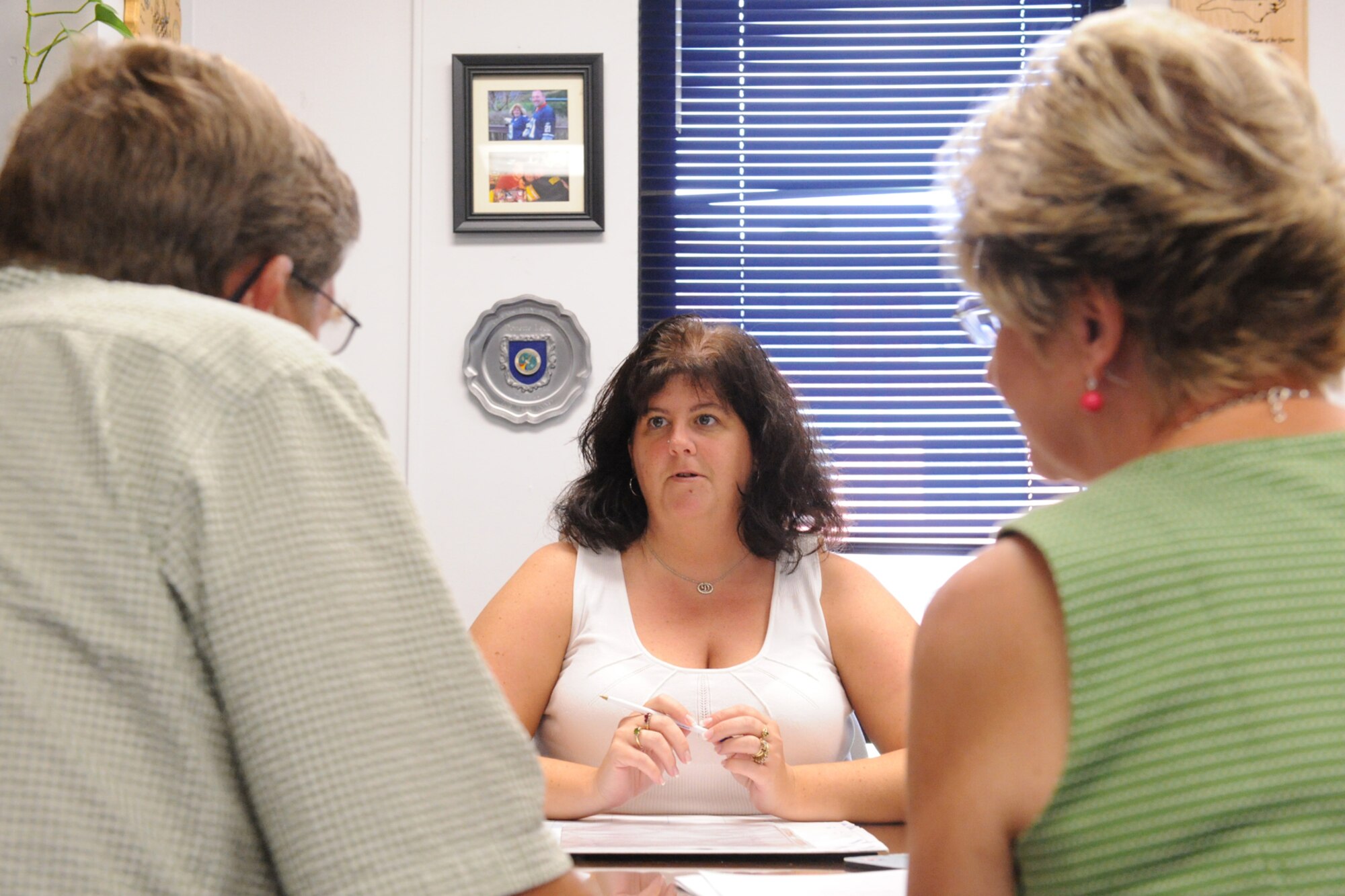 Donette Legg, 4th Fighter Wing legal office secretary, assists Edwin and Yvonne Modlin with their wills on Seymour Johnson Air Force Base, N.C., July 30, 2009. Mrs. Legg has worked at the legal office for more than five years helping only active duty members, dependents and retirees with legal needs. (U.S. Air Force photo by Airman 1st Class Whitney S. Lambert)  