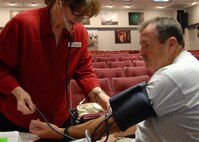 Marilyn Leggett, 96th Medical Group, takes Chester Arrant’s, 919th Maintenance Squadron, blood pressure as part of a cholesterol and blood pressure screening for civilians Aug. 5 at Duke Field.  The screening is part of the civilian health promotion service to make government civilians aware of their health and provide tips on nutrition, exercise and an active lifestyle.  (U.S. Air Force photo/Staff Sgt. Samuel King Jr.)