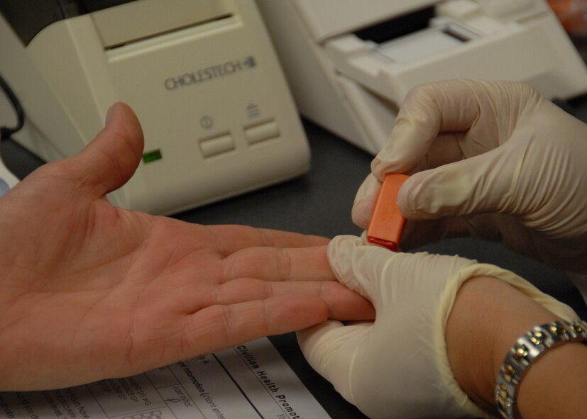 A medical technician prepares to prick a finger as part of a cholesterol and blood pressure screening for civilians Aug. 5 at Duke Field.  The screening is part of the civilian health promotion service to make government civilians aware of their health and provide tips on nutrition, exercise and an active lifestyle.  (U.S. Air Force photo/Staff Sgt. Samuel King Jr.)