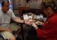 Chester Arrant, 919th Maintenance Squadron, has blood drawn by Marilyn Leggett, 96th Medical Group, as part of a cholesterol and blood pressure screening for civilians Aug. 5 at Duke Field.  The screening is part of the civilian health promotion service to make government civilians aware of their health and provide tips on nutrition, exercise and an active lifestyle.  (U.S. Air Force photo/Staff Sgt. Samuel King Jr.)
